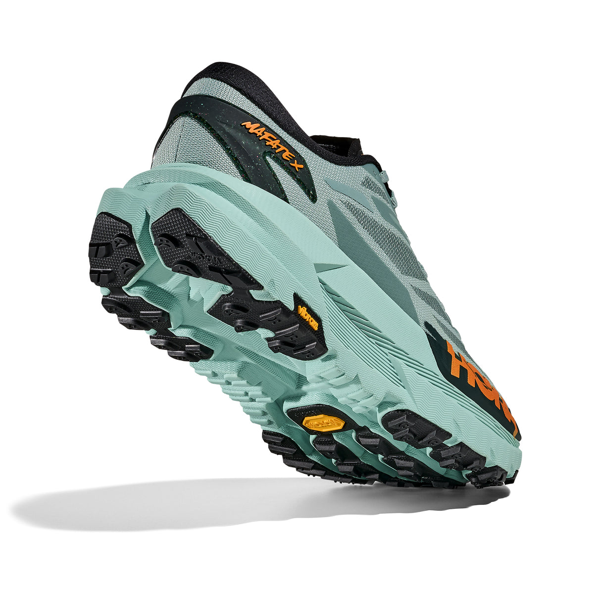 HOKA Mafate X men's trail running shoe in Sage / Rosemary — angled side view showing sage woven textile upper, forked carbon fibre plate profile, MetaRocker™ geometry and rosemary dual-density midsole stack