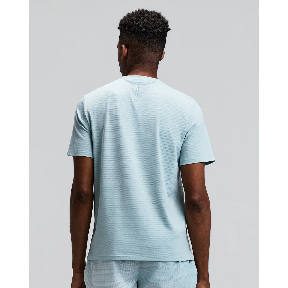 Men's Bandit Micromesh Run Tee Lagoon back view on male runner showing breathable Micromesh construction with fast-drying sweat-wicking fabric for comfortable running