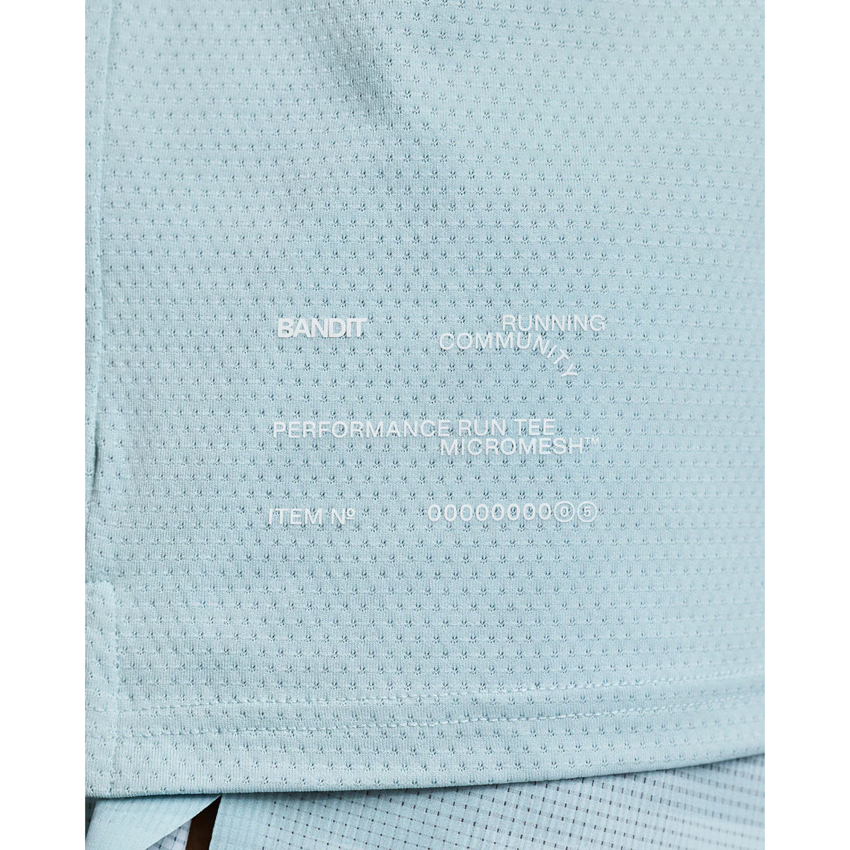 Men's Bandit Micromesh Run Tee Lagoon close-up of hem showing subtle two-tone Bandit logo with reflective details for low-light visibility during running
