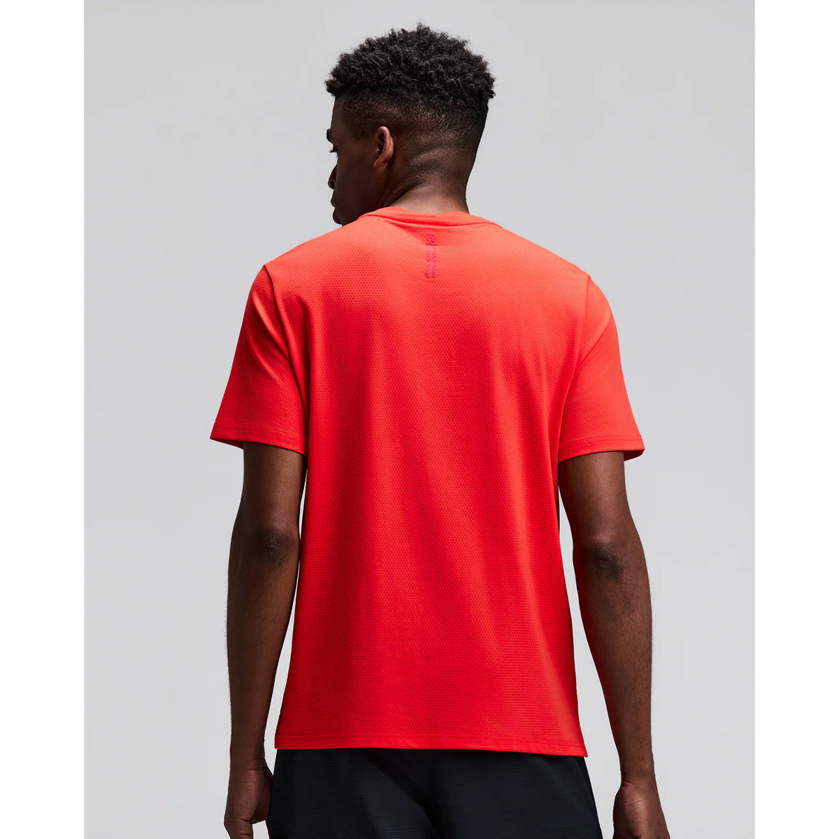 Men's Bandit Micromesh Run Tee Poppy back view on male runner showing breathable Micromesh construction with fast-drying sweat-wicking fabric for comfortable running