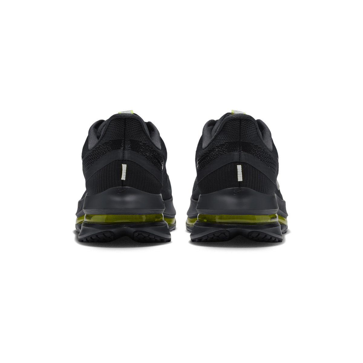 Back view of Nike Men’s Pegasus Premium Running Shoes in Dark Shadow, Black, and Yellow Venom, showcasing green transparent soles and triple-layer cushioning for enhanced energy return, set against a plain white background.