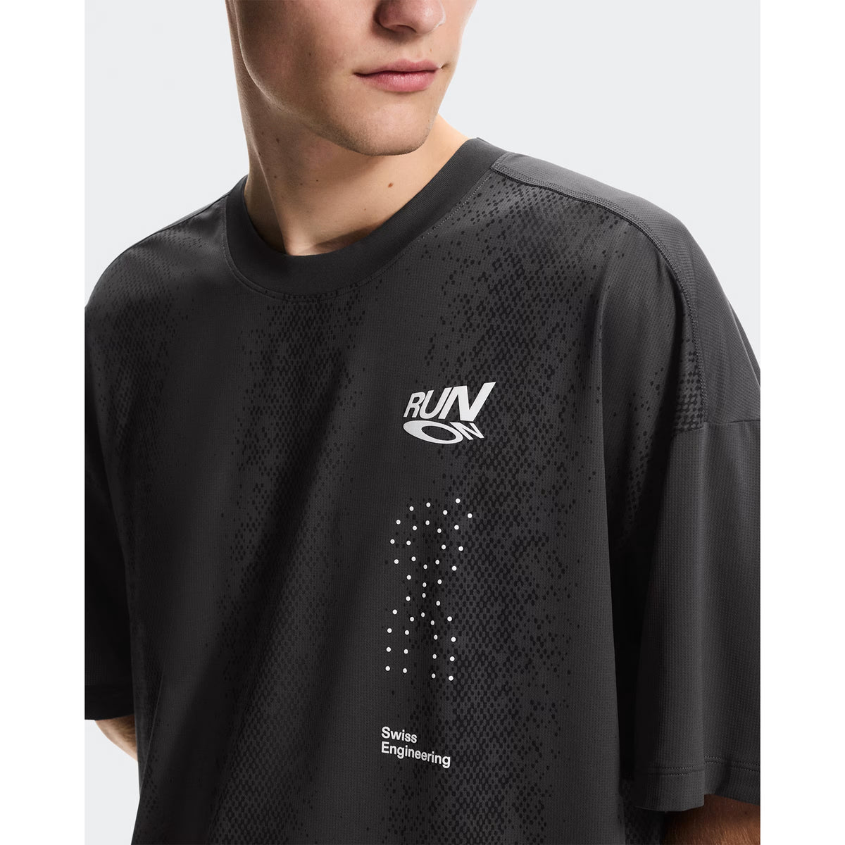 Men's On Performance Volt-T Iron close-up front showing expressive run-culture graphics with typographic elements and quick-drying fabric construction
