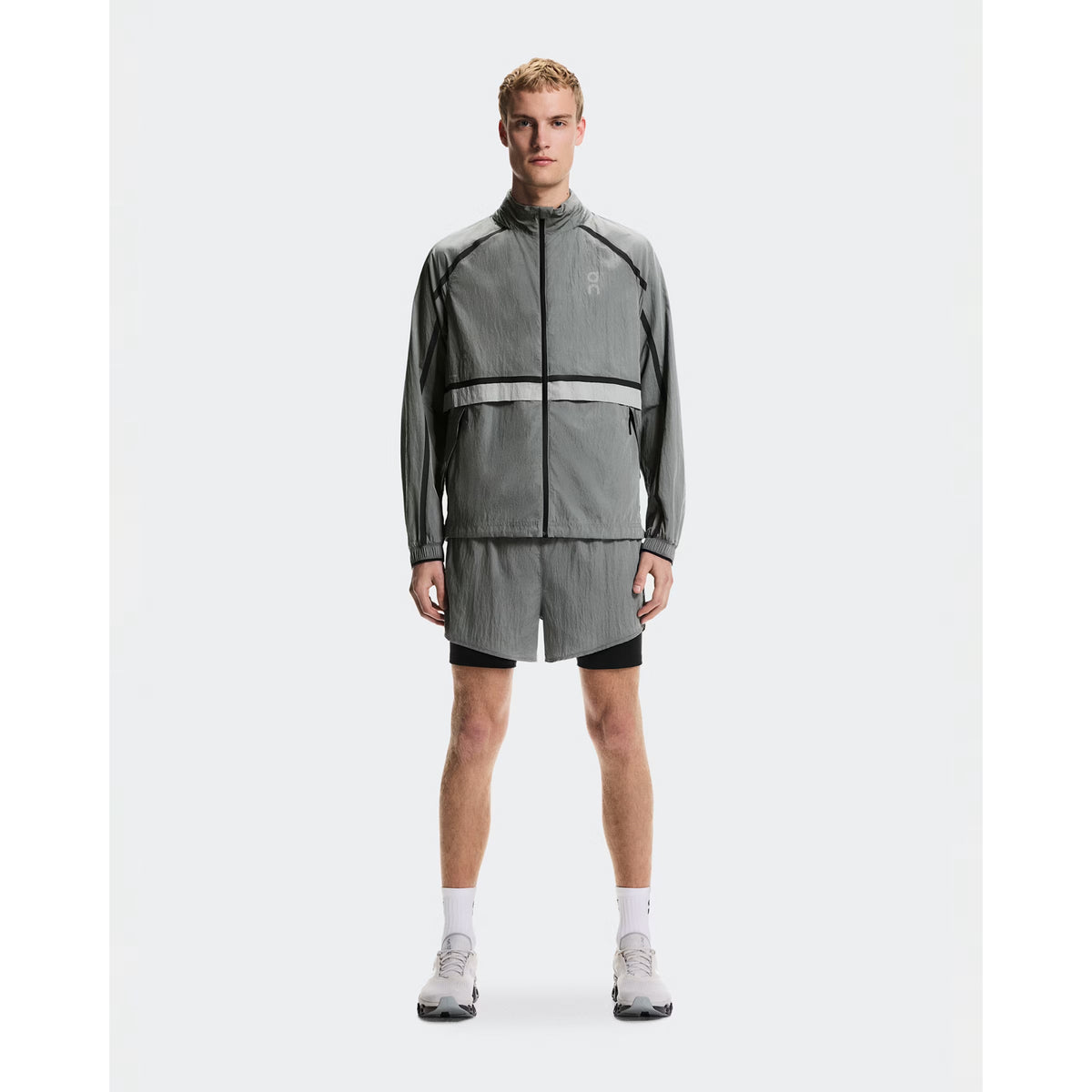 Men's On Performance Volt Shorts Glacier full body front view on male runner showing dual-layer design with windproof outer and moisture-wicking inner for everyday training