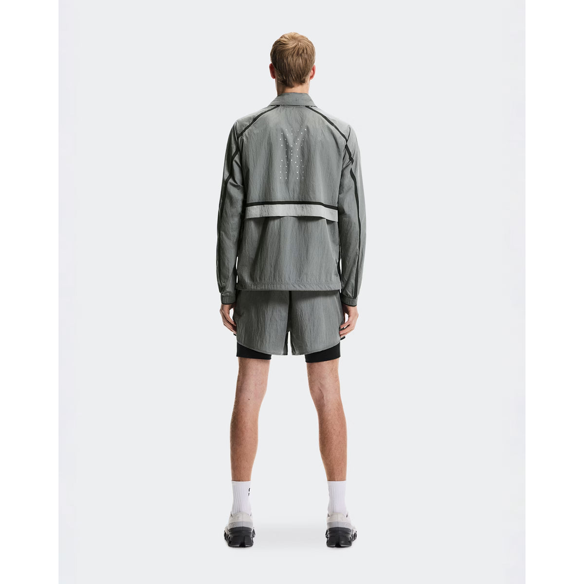 Men's On Performance Volt Shorts Glacier full body back view on male runner showing additional back pocket storage and water-repellent iridescent outer layer