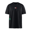 District Vision Men’s Short Sleeve Boxy Training Tee in black, featuring a crewneck, breathable stretch fabric, a small red flame graphic on the chest, and a green side seam tag.