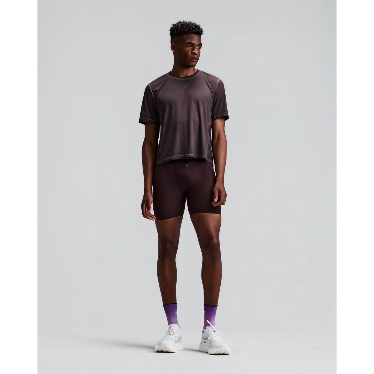 Men's Bandit SoLite Quarter Tights Espresso front full body view on male runner showing featherweight SoLite compression with waterproof drop-in leg pockets and GripDot hem grip for road running and racing