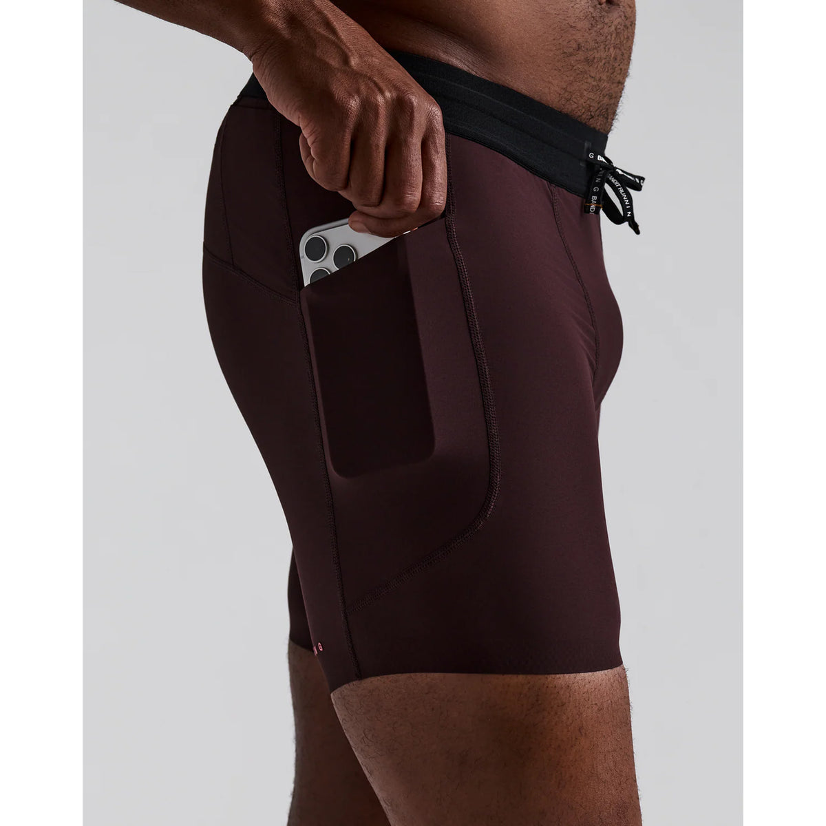 Men's Bandit SoLite Quarter Tights Espresso side view showing SoLite featherweight compression with GripDot hem grip and waterproof pocket system for comfortable racing and training