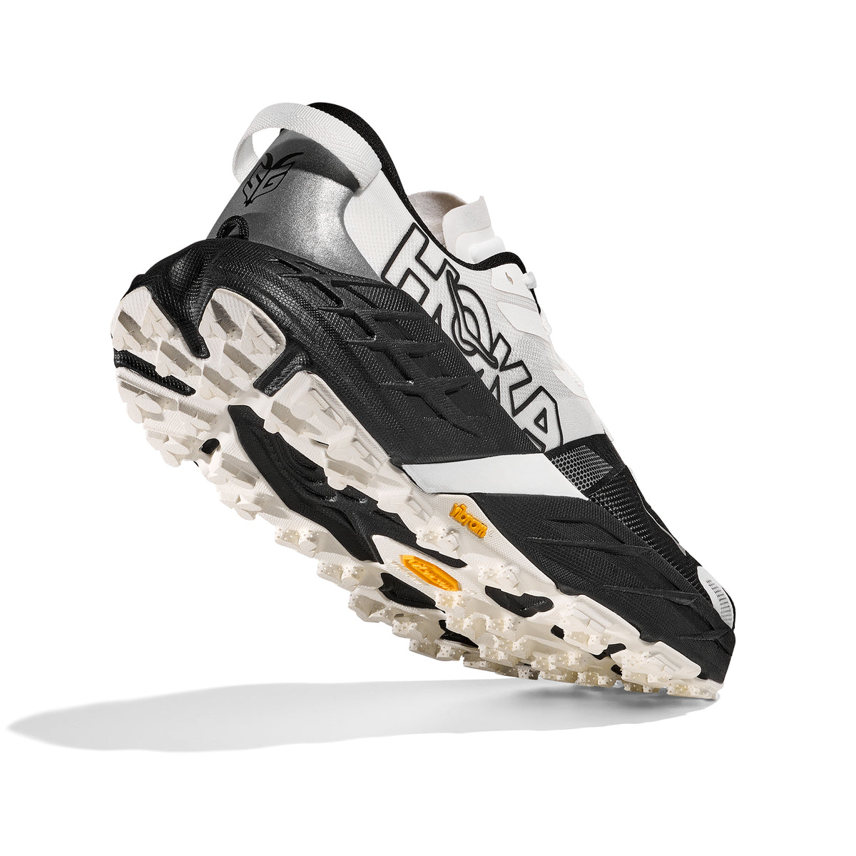 Men's Speedgoat 7 Wide Fit Trail Running Shoes Black White angled side view showing Vibram® Megagrip outsole with 5mm traction lug