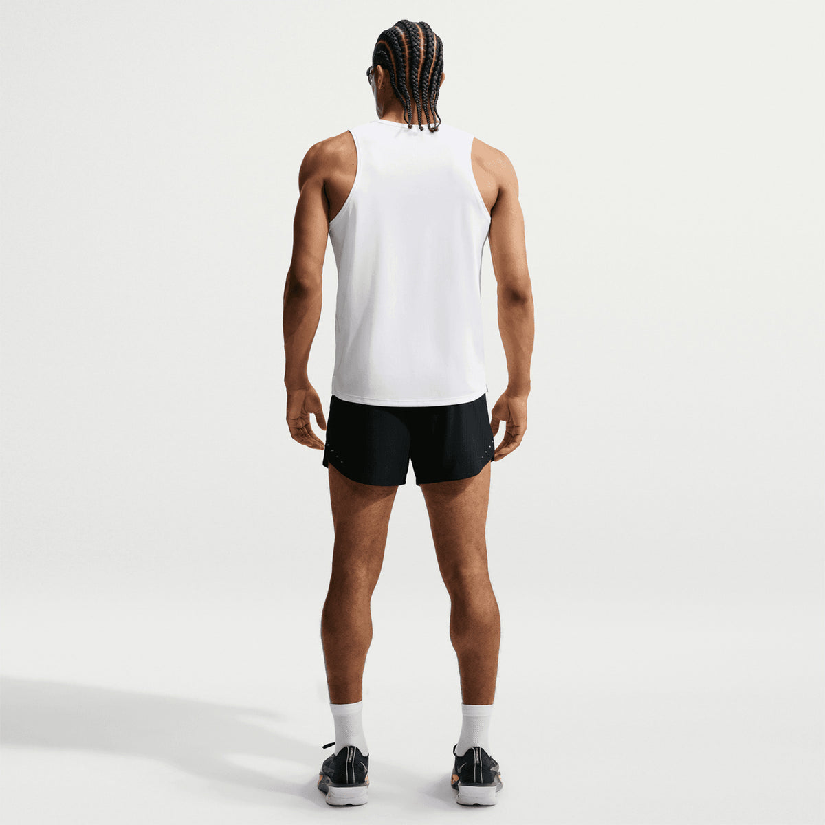Men's Nike Stride Aero-FIT 5 Inch Shorts Black full body back view on male runner showing zippered phone pocket with Aero-FIT jacquard knit co