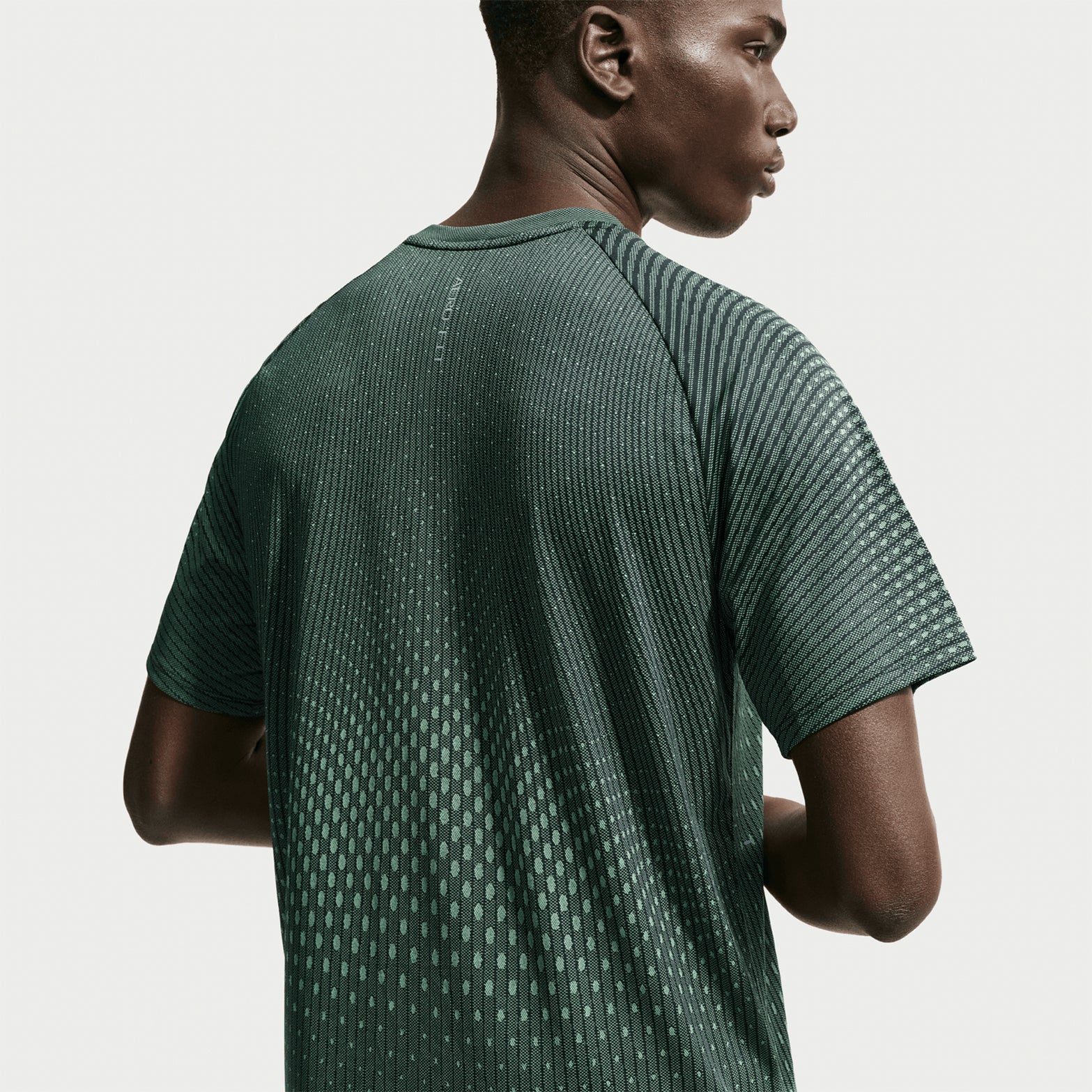 Men's Nike Stride Aero-FIT Running Tee Black Light Green Spark back view showing strategic mesh zones with Aero-FIT airflow construction for active cooling during running