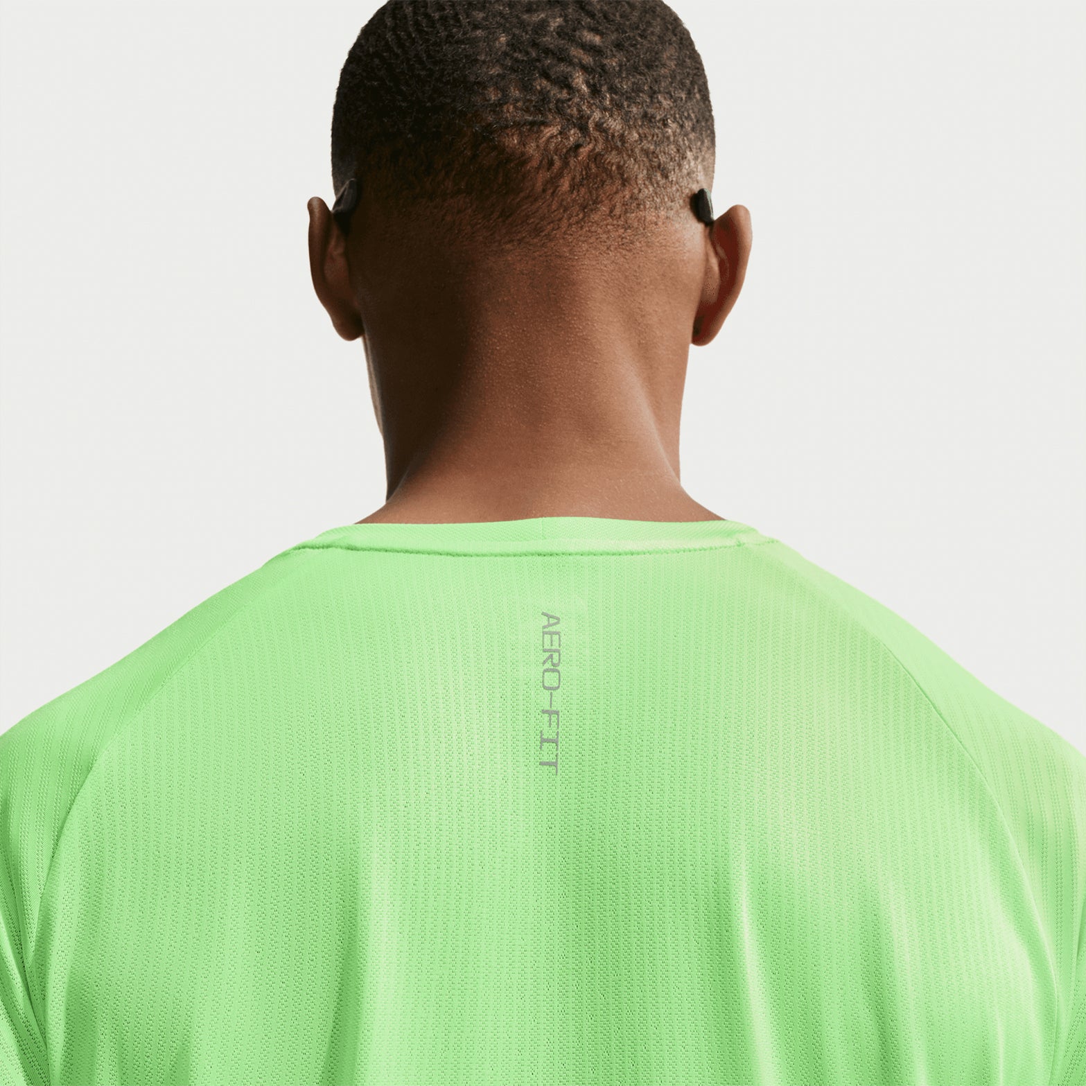Men's Nike Stride Aero-FIT Running Tee Volt Light Silver back view showing strategic mesh zones with Aero-FIT airflow construction for active cooling during running