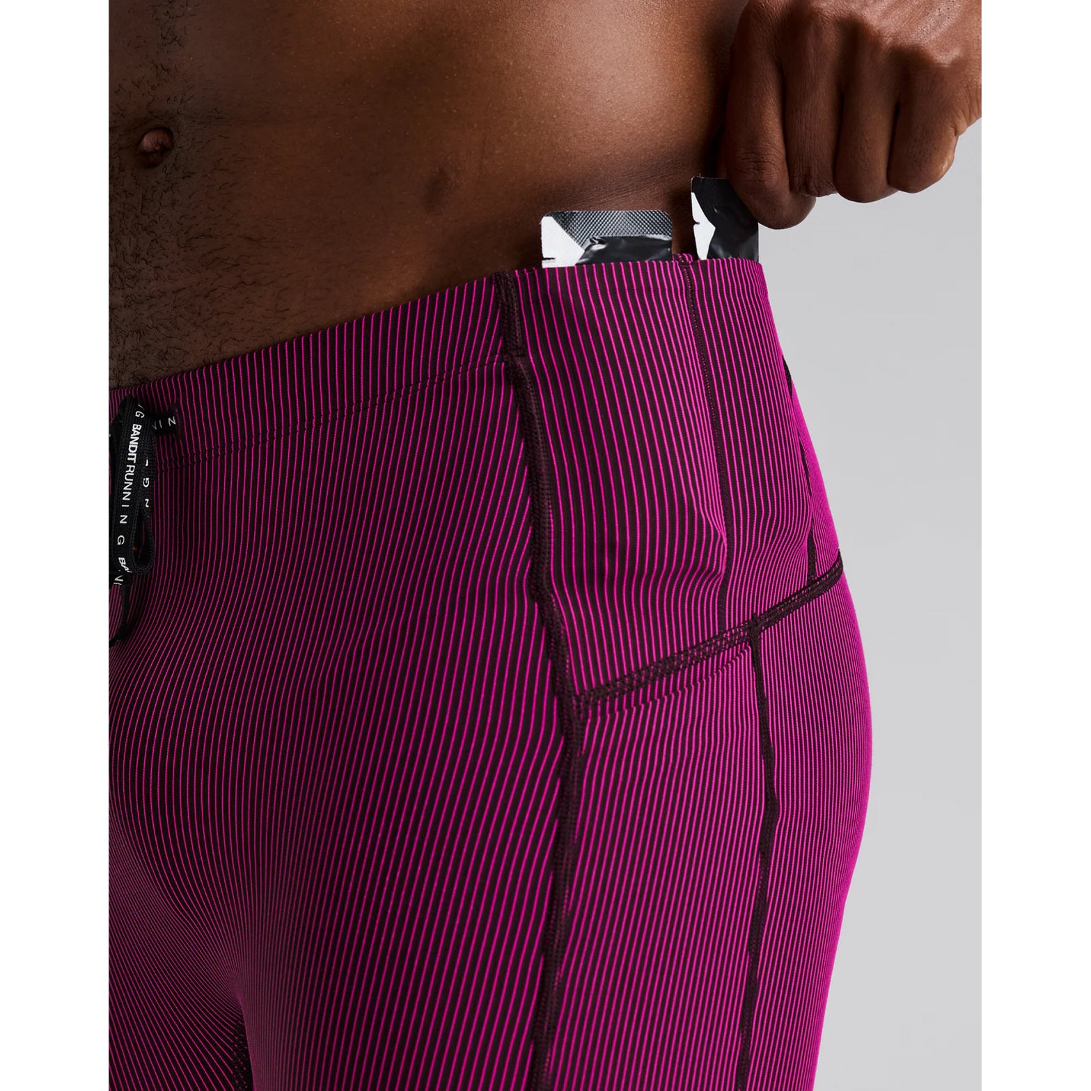 Men's Bandit Striped Cadence Quarter Tights Espresso Azalea close-up of gel pocket showing secure dedicated nutrition storage with zero-bulk design for race day fuelling without bounce