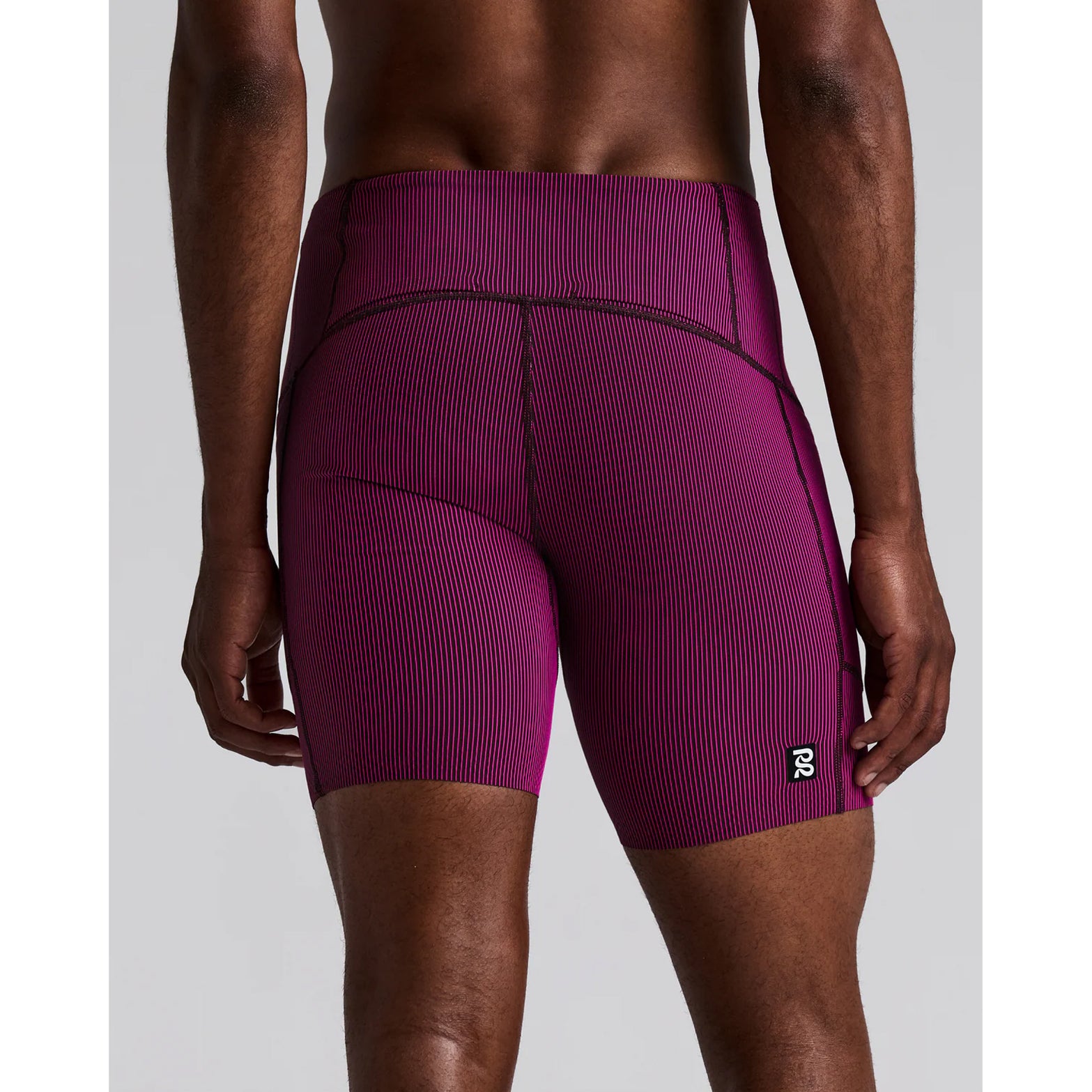 Men's Bandit Striped Cadence Quarter Tights Espresso Azalea back view on male runner showing waterproof centre back waistband phone pocket with tee loop and four gel pockets on back panel