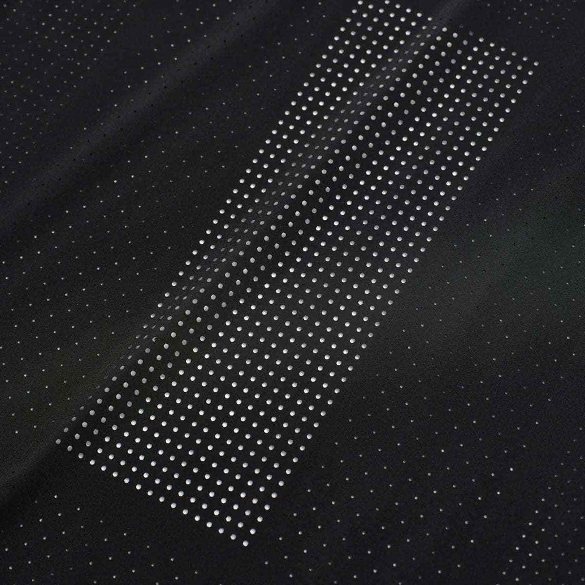 Men's Raide Thermal Dispersion Tee Black close-up of 115gsm Italian-knit microfibre showing cool-to-touch construction with four-way stretch and laser-cut perforation detail for lightweight breathable running