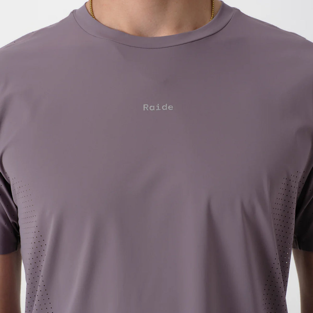 Men's Raide Thermal Dispersion Tee Dusk close-up of front showing reflective Raide branding with body-mapped laser-cut perforations and cool-to-touch 115gsm Italian-knit microfibre construction