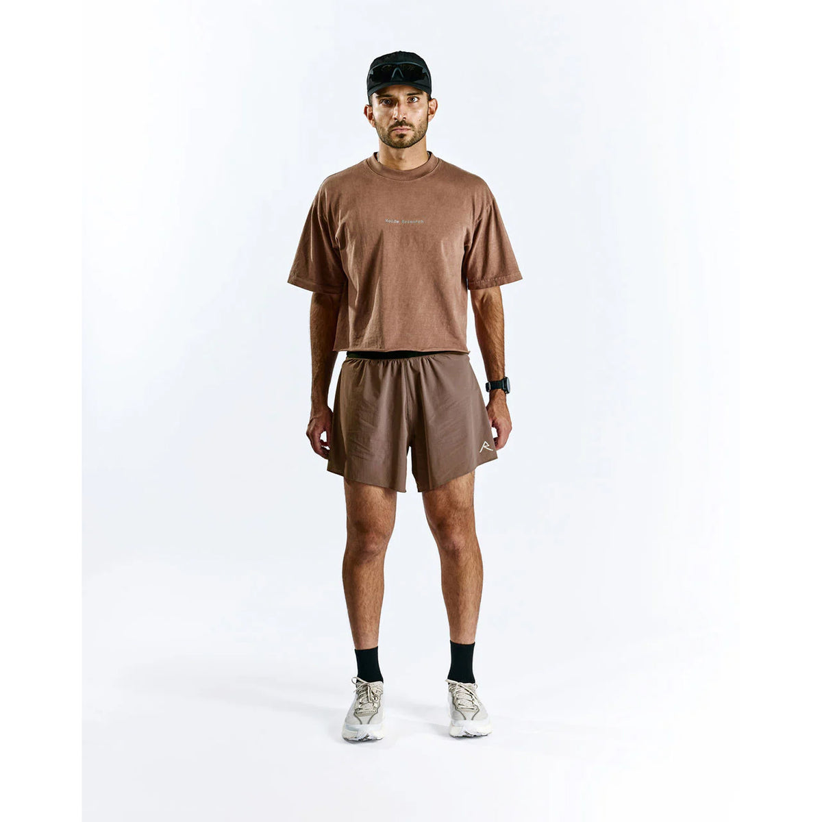 Raide TrailTech Short men's in Bark — full body front view worn on model showing 5.25 inch silhouette, laser-perforated waistband and pocket placement in motion on trail