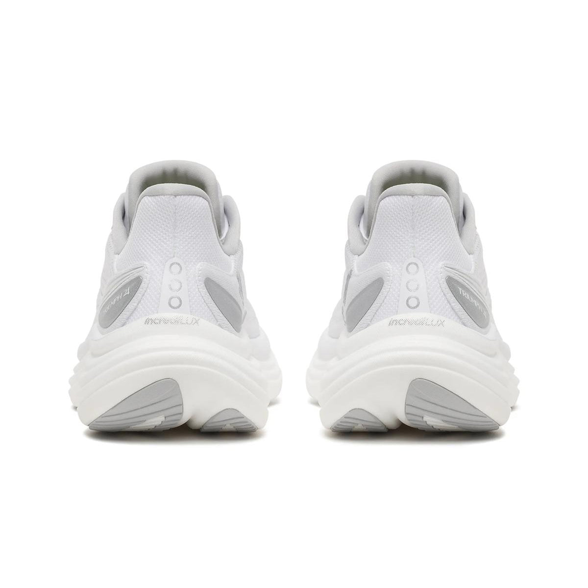 Two white and silver men’s running shoes, the Saucony Triumph 24, are viewed from the back to showcase the heels and soles. The shoes feature gray accents, text detailing near the heel areas, and premium cushioning with Incredilux™ foam for exceptional comfort. The background is plain white.