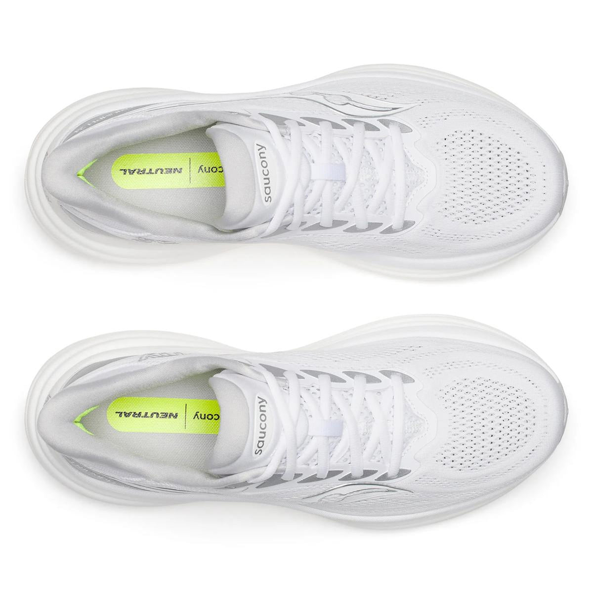 Top view of a pair of Men’s Triumph 24 Running Shoes in White / Silver, featuring white laces and mesh uppers. The yellow insoles display the Saucony logo alongside the word “NEUTRAL” in black text. These shoes are equipped with incrediLUX foam for premium cushioning, delivering a comfortable and responsive ride.