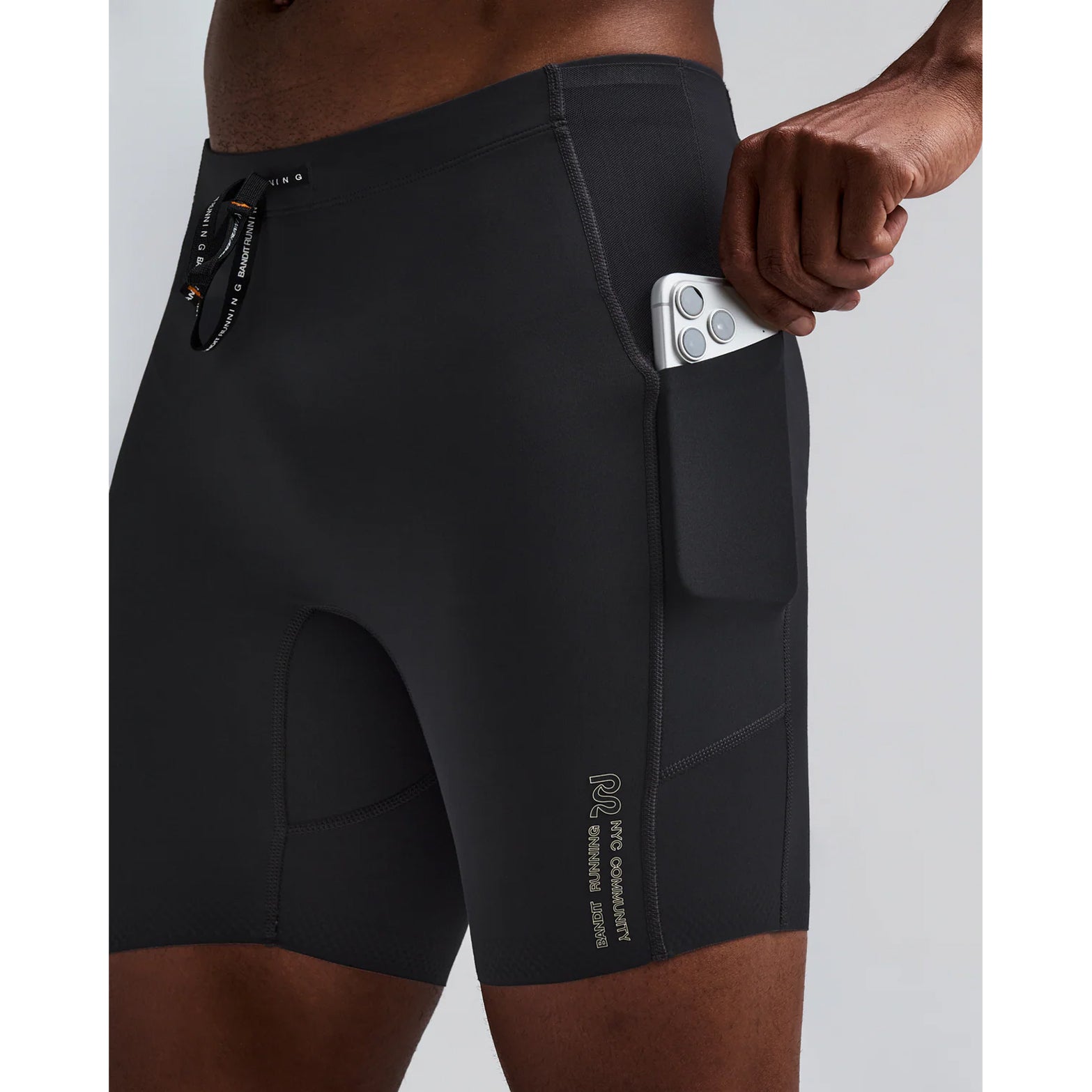 Men's Bandit Vanisher Quarter Tights Anthracite side view on male runner showing Vanisher compression with waterproof side leg phone pocket and GripDot hem for comfortable race day performance