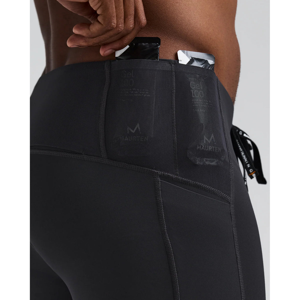 Men's Bandit Vanisher Quarter Tights Anthracite close-up of Powermesh back panel gel pockets showing four dedicated nutrition storage pockets with zero-bulk design for race day fuelling without bounce