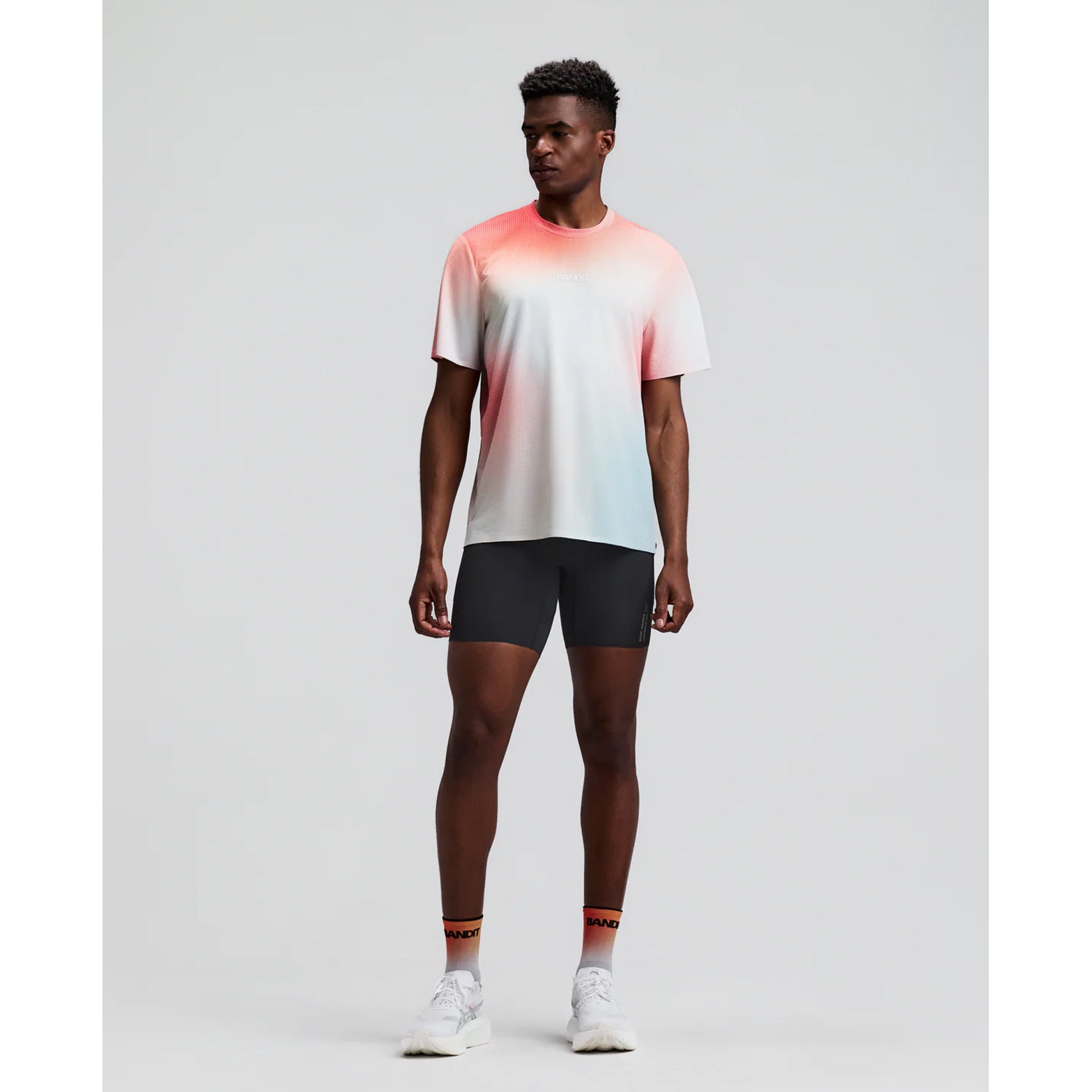 Men's Bandit Vanisher Quarter Tights Anthracite front full body view on male runner showing Vanisher sweat-hiding compression with GripDot hems and seven-pocket system for road running and racing