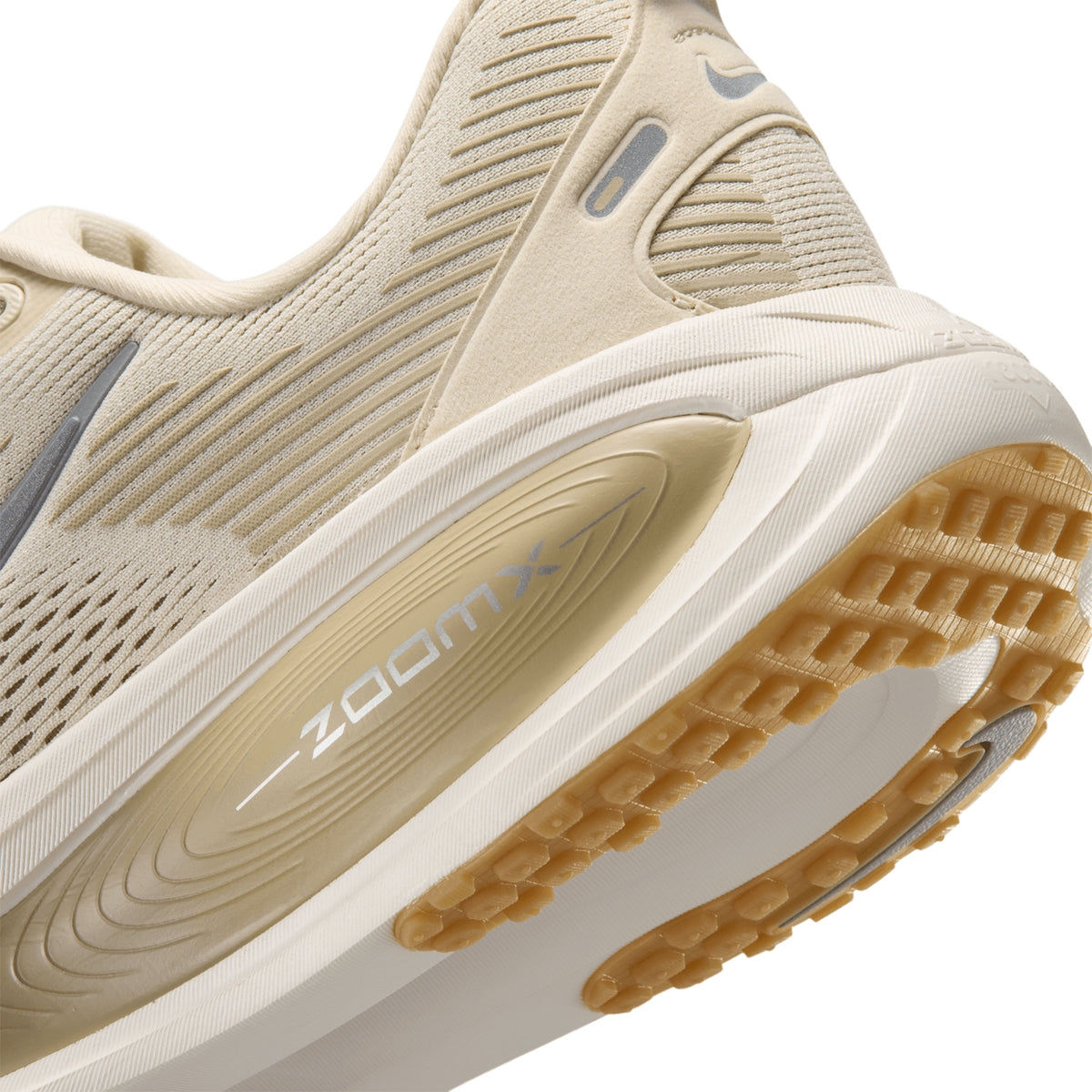 Men's Nike Vomero 18 Running Shoes Light Khaki Desert Khaki Sail Metallic Silver angled side and heel view showing stacked ZoomX and ReactX foam with redesigned traction pattern and strategic outsole pods for plush responsive everyday road running