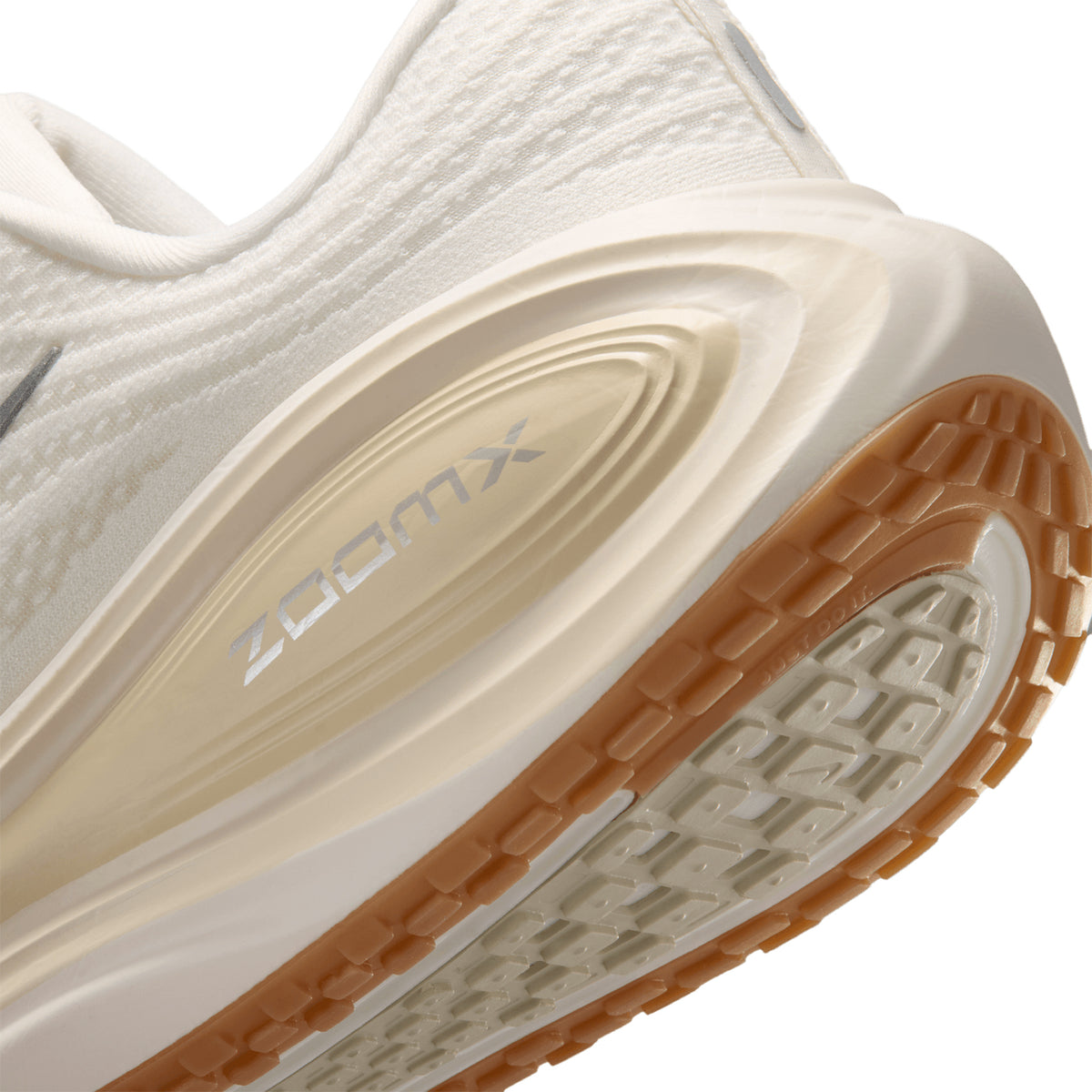 Men's Nike Vomero Plus Running Shoes Sail Coconut Milk Light Khaki Metallic Silver angled side and heel view showing full-length ZoomX foam with high-abrasion outsole and soft breathable mesh upper for maximum cushioned everyday road running
