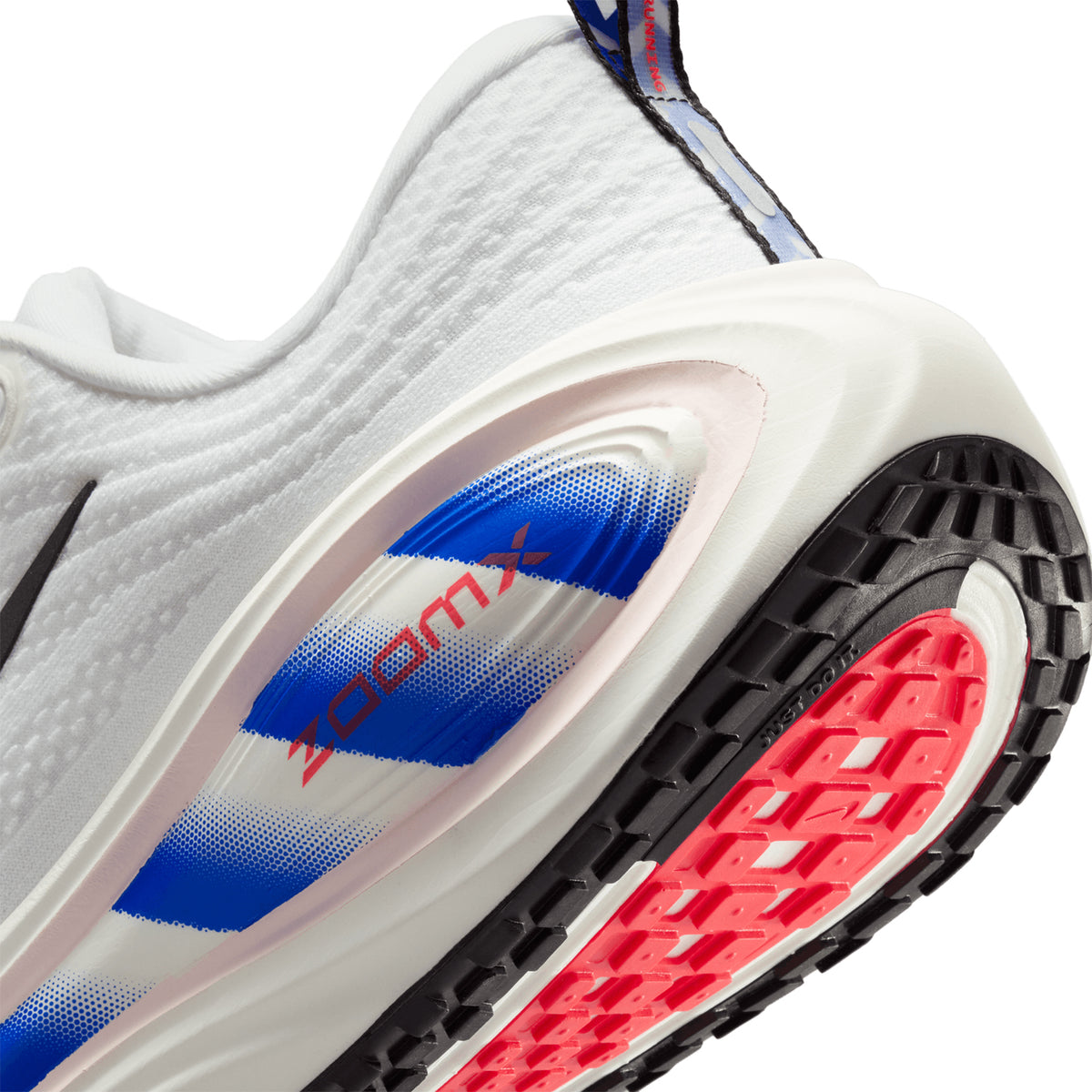 Men's Nike Vomero Plus Running Shoes White Black Racer Blue Bright Crimson angled side and heel view showing premium cushioning with dual Air Zoom and ZoomX foam platform for comfortable daily running