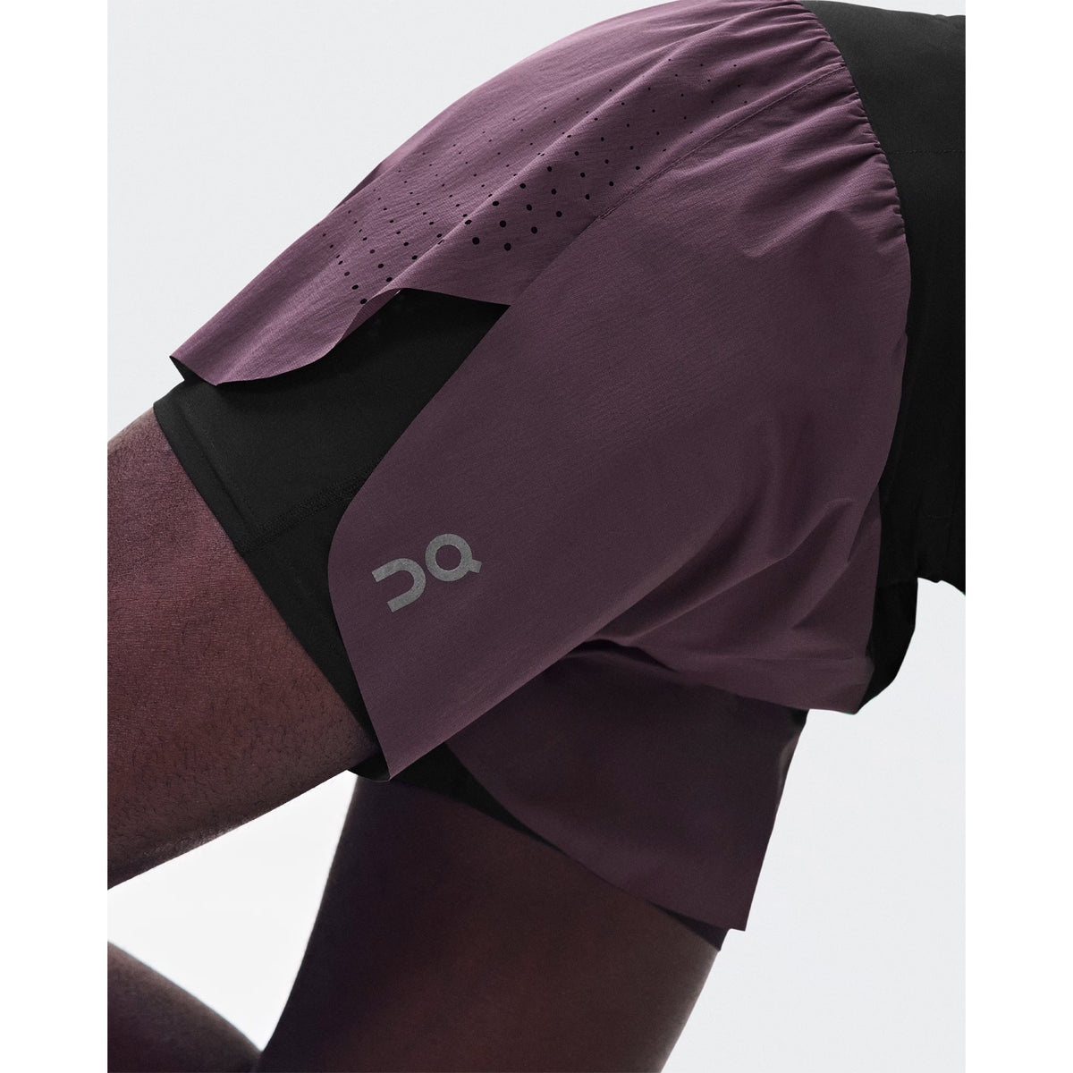 Men's On Zero 2-in-1 Shorts Urchin Black side view on male runner showing ultralight loose outer with On DryTec inner shorts and adjustable drawcord waistband for distraction-free training