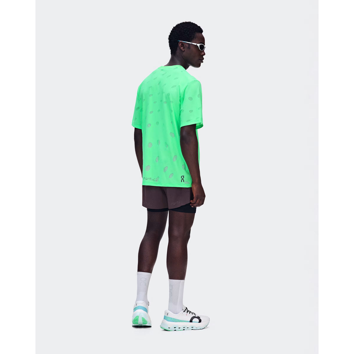 Men's On Zero 2-in-1 Shorts Urchin Black back full body view on male runner showing perforated ventilation with zip pocket, gel storage and reflective detailing for comfortable race day and training performance