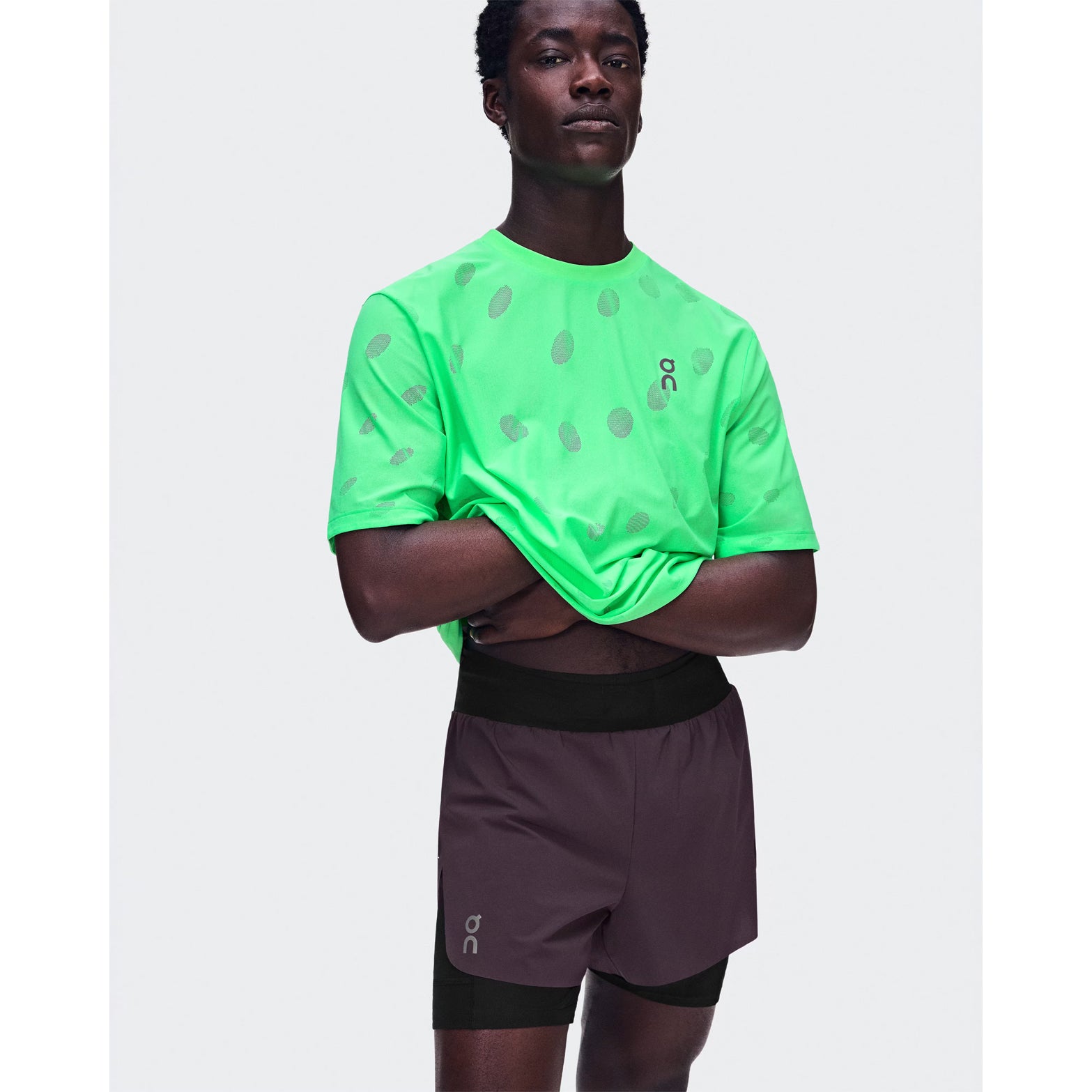 Men's On Zero 2-in-1 Shorts Urchin Black front view on male runner showing ultralight perforated outer with On athlete-inspired graphic and adjustable drawcord waistband for training performance