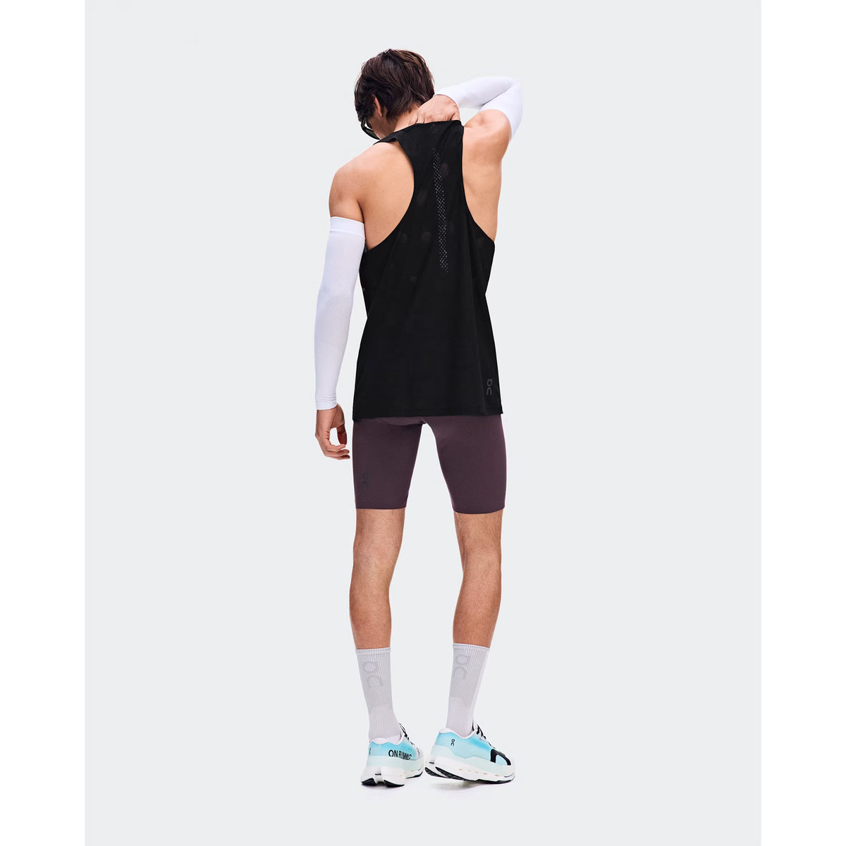 Men's On Zero Half Tights Urchin back full body view on male runner showing engineered bonded back pockets with OAC-inspired graphic and lightweight technical fabric for comfortable race day running