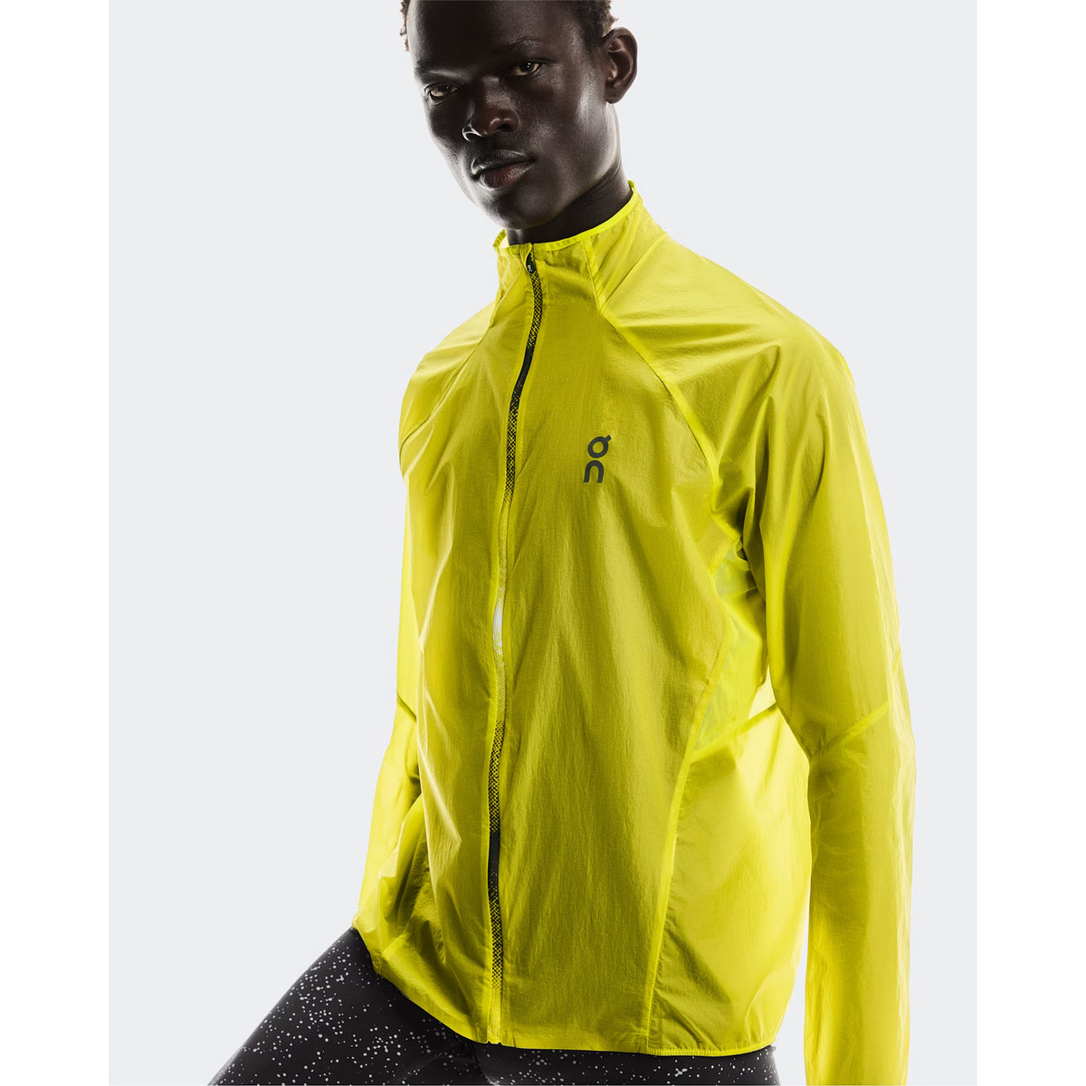 Men's On Zero Jacket Lime close-up front showing spiral dart elbow construction for enhanced arm mobility and featherlight water-repellent fabric