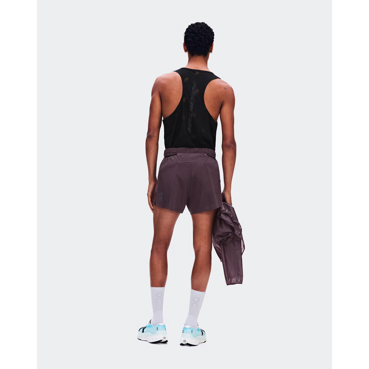 Men's On Zero Shorts Urchin back full body view on male runner showing zip pocket and gel storage with perforated ventilation outer for practical comfortable race day performance