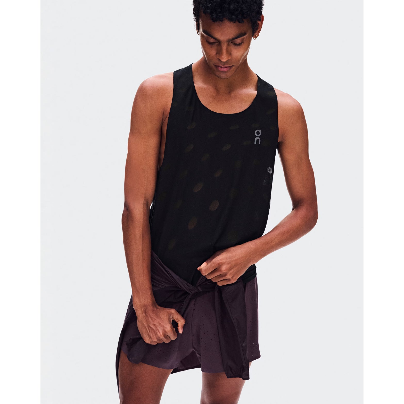 Men's On Zero Tank Breathe Black front view on male runner showing ultralight DryTec breathable jacquard construction with minimalist distraction-free fit for fast training