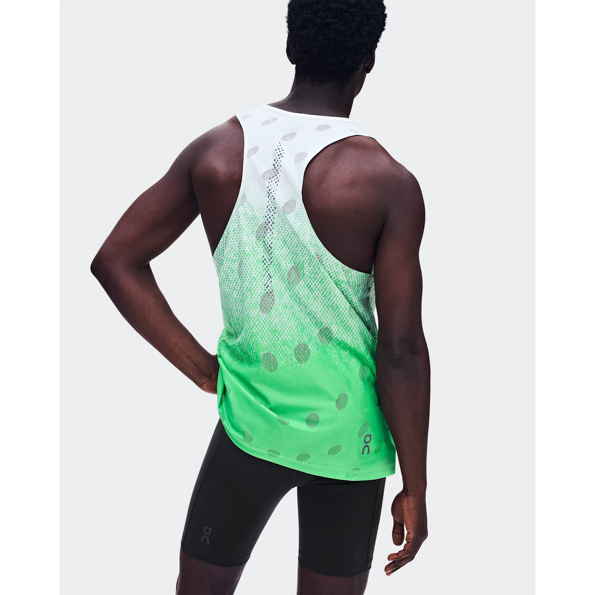Men's On Zero Tank Breathe Verdite back view on male runner showing functional jacquard construction with reflective detailing and On DryTec moisture-wicking fabric
