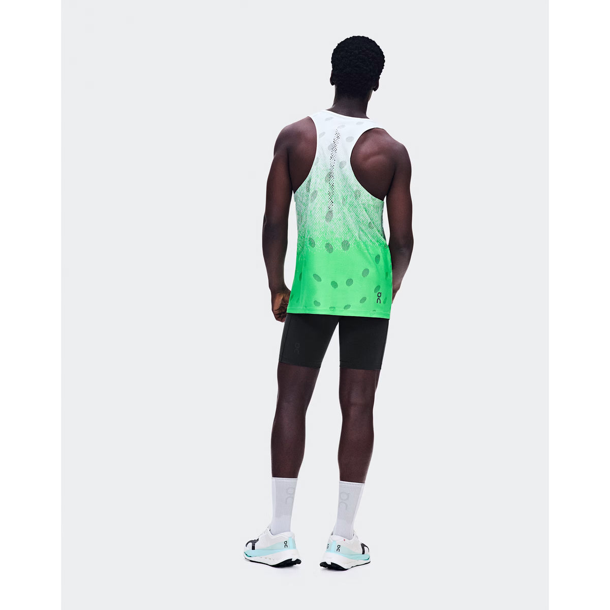 Men's On Zero Tank Breathe Verdite back full body view on male runner showing functional jacquard construction with signature reflective detailing and On DryTec quick-drying fabric for high-paced running