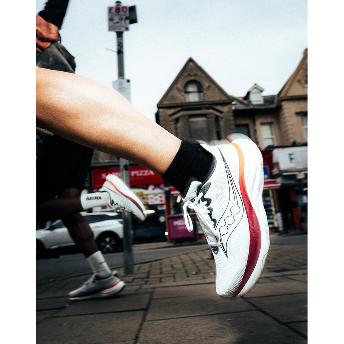 Men's Saucony Ride 19 Running Shoes White Black worn by male runner showing fit and PWRRUN+ midsole profile on road