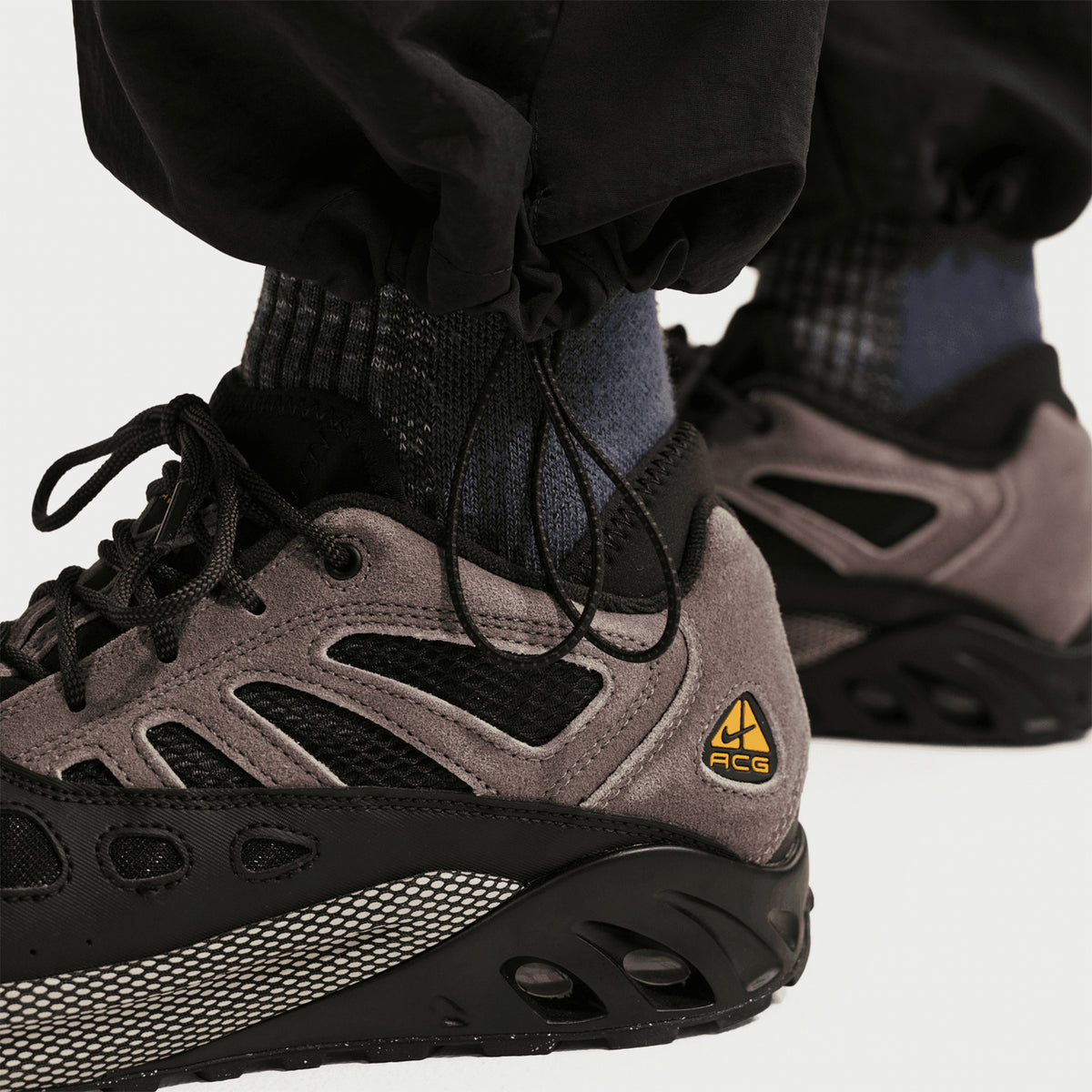 Nike Men's ACG Dolomiti Trousers Black Summit White bottom close-up showing adjustable bungees at hem for fit customisation