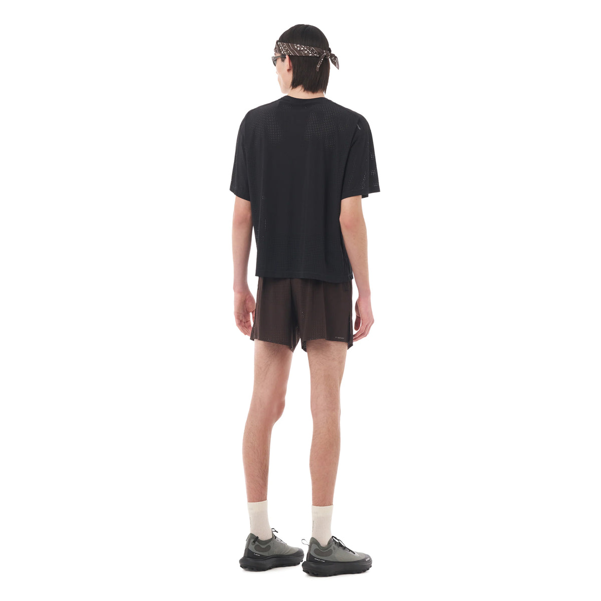 Satisfy Space-O Tee Black full body back view on male runner showing ultra-breathable fast-drying fabric with stealth-reflective logo for low-light visibility