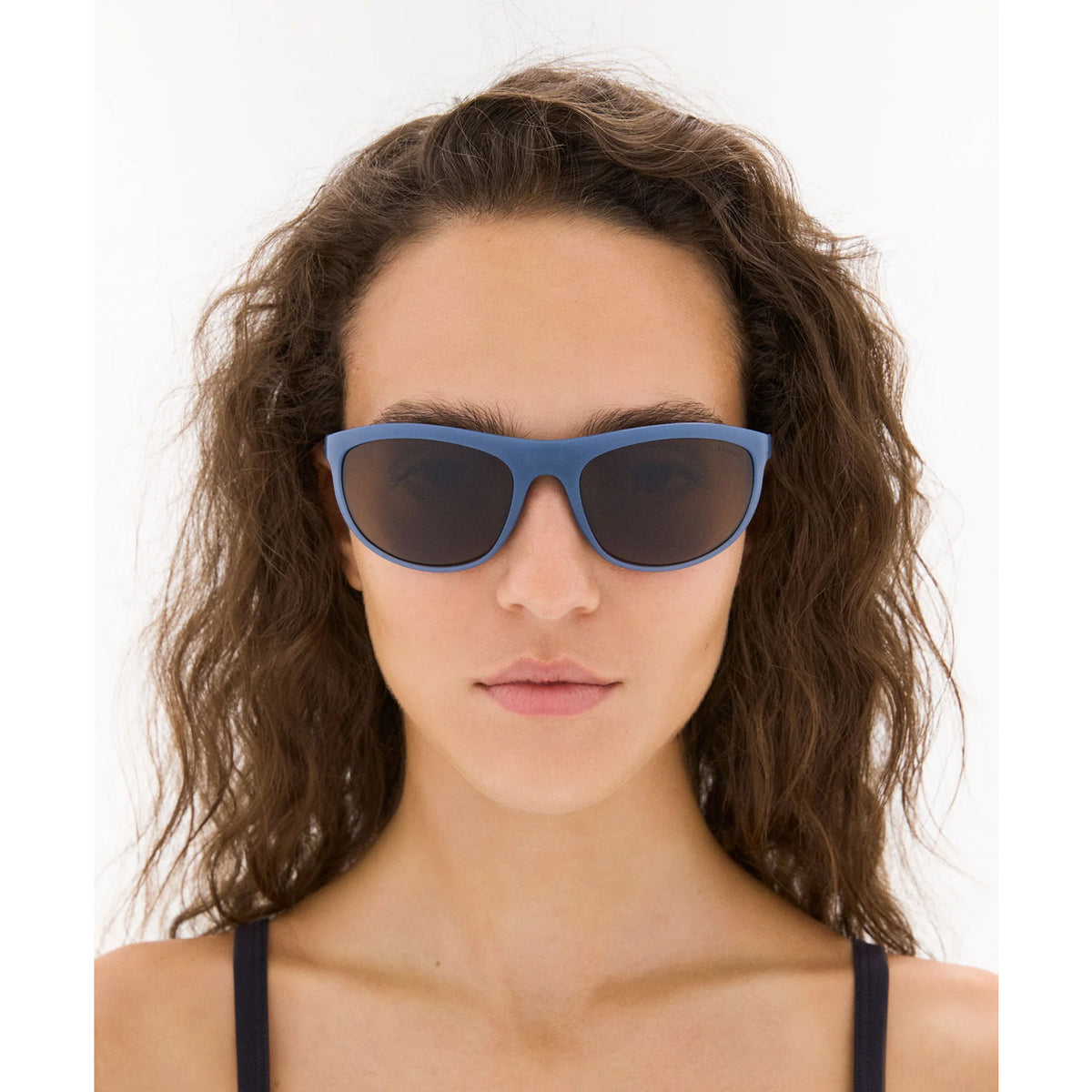 District Vision Takeyoshi Altitude Master in Cold Water D+ Copper — worn on female model showing eight-base frame fit, cold water colourway and D+ Copper lens in natural light