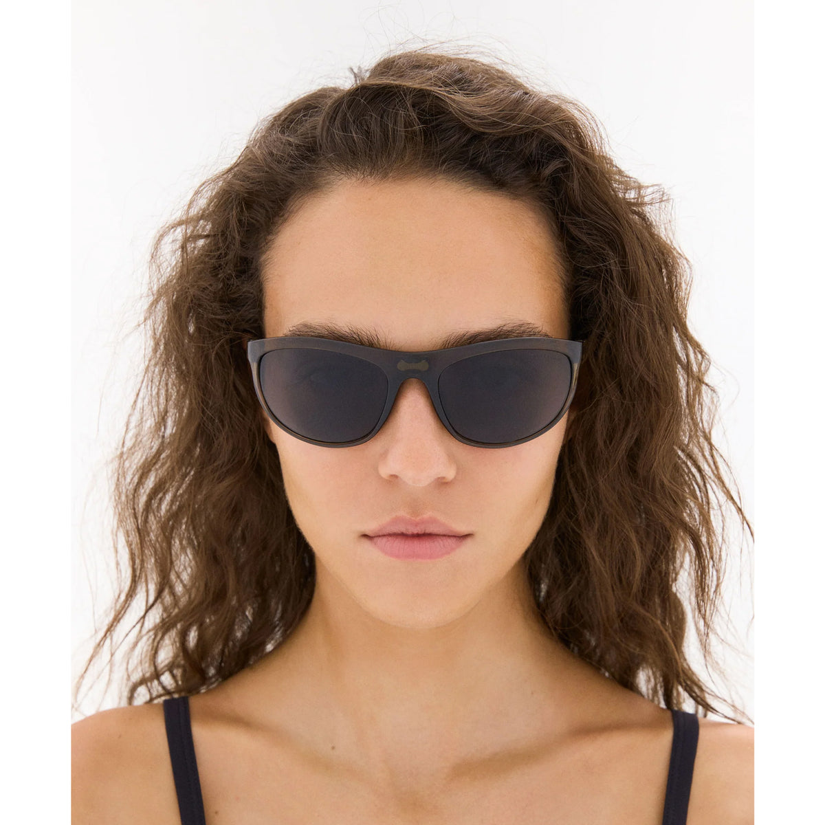 District Vision Takeyoshi Altitude Master in Liquid Moss D+ Water Grey — worn on female model showing eight-base frame fit, liquid moss colourway and D+ Water Grey lens in natural light