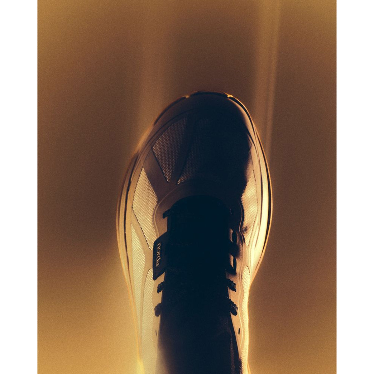 Women's norda 055 Trail Running Shoes Strato creative product shot in dramatic illuminating lighting showcasing the bio-circular Dyneema upper with 360-degree reflective detailing and seamless knit sock collar construction