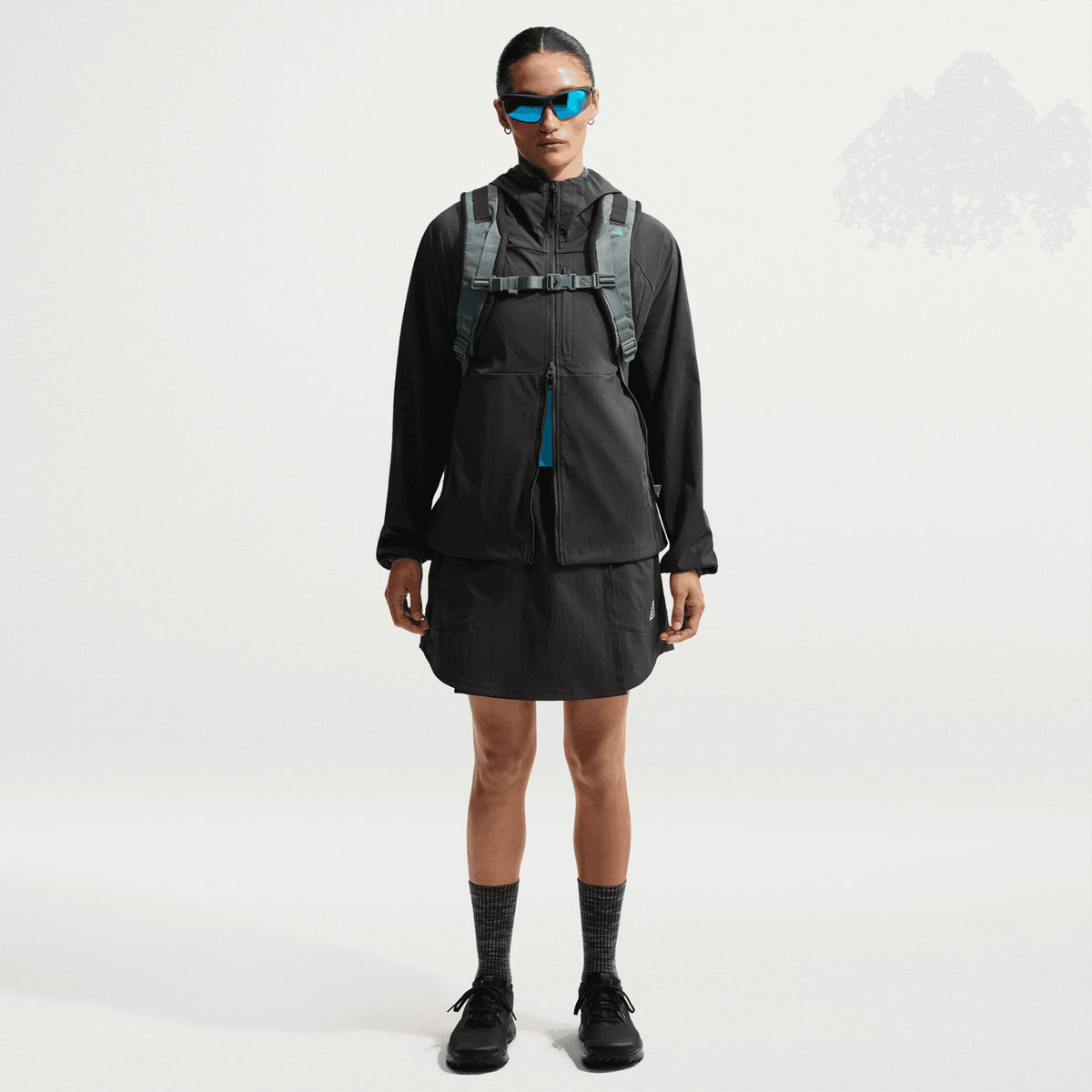 Women's Nike ACG Five Towers Skort Anthracite Summit White front full body view on female runner showing convertible skort design with buttons for switching between skirt, shorts or skort configuration