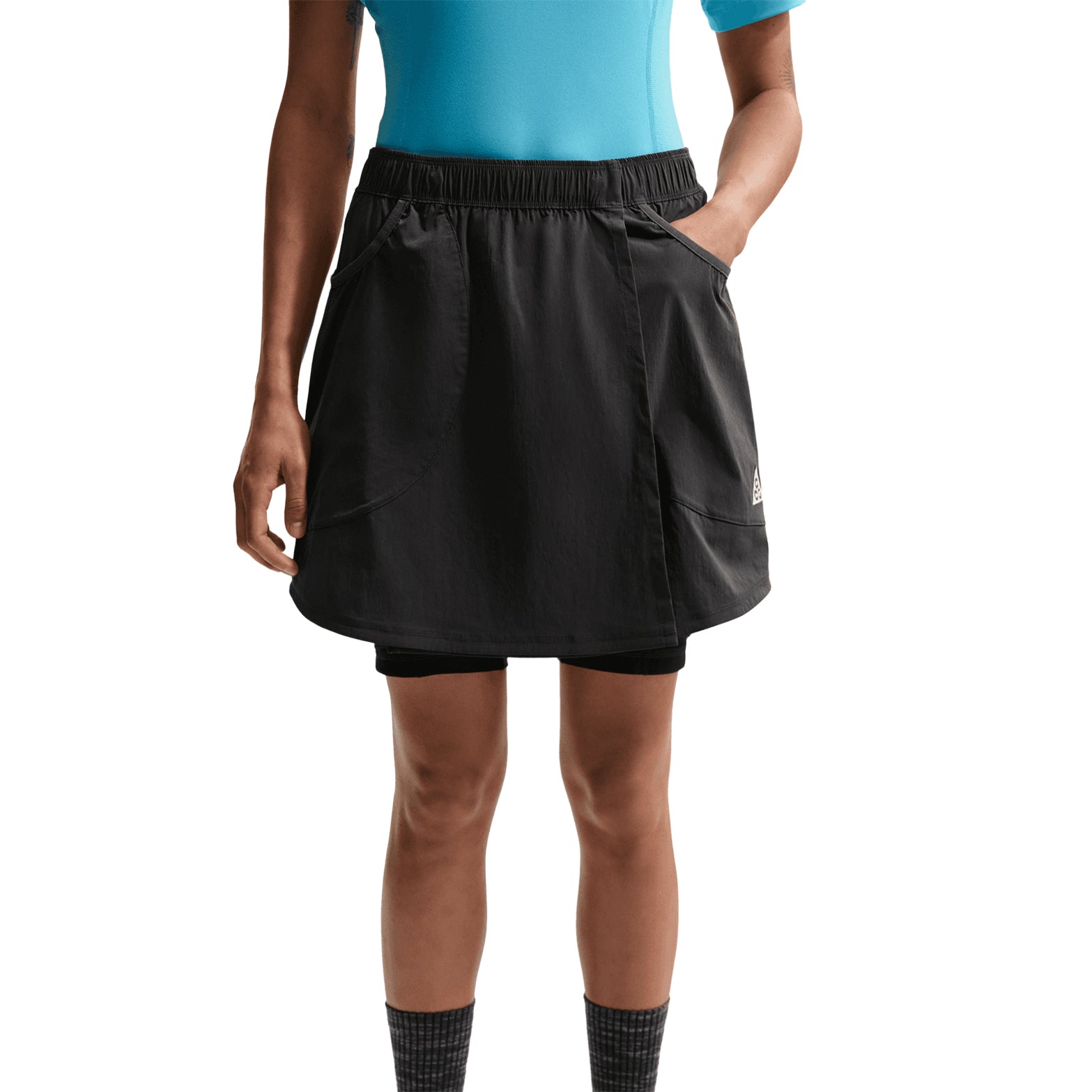 Women's Nike ACG Five Towers Skort Anthracite Summit White front view on female runner showing convertible three-way design with Dri-FIT moisture-wicking and embroidered ACG logo