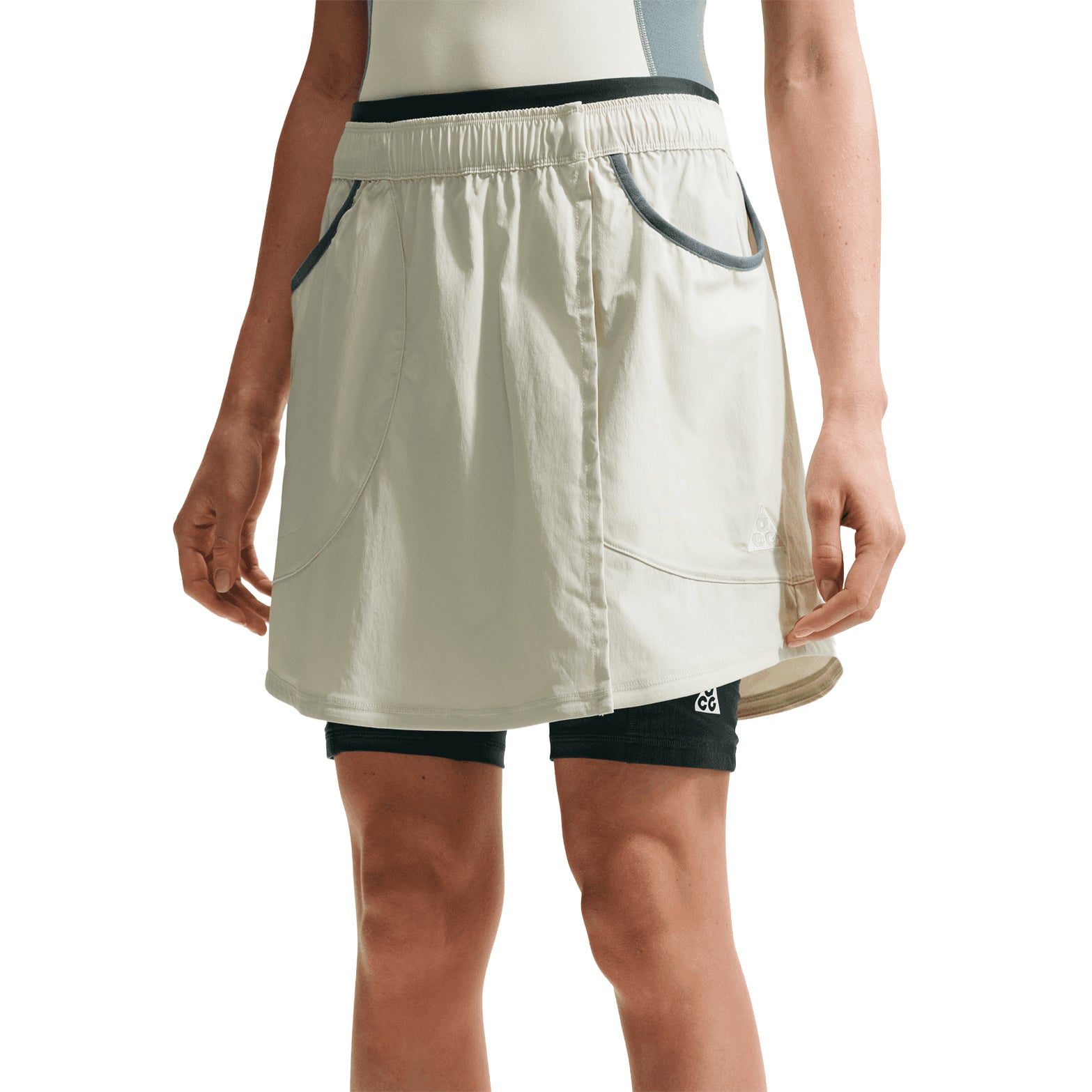 Women's Nike ACG Five Towers Skort Sea Glass Spruce Fog Summit White front view on female runner showing convertible three-way design with Dri-FIT moisture-wicking and embroidered ACG logo
