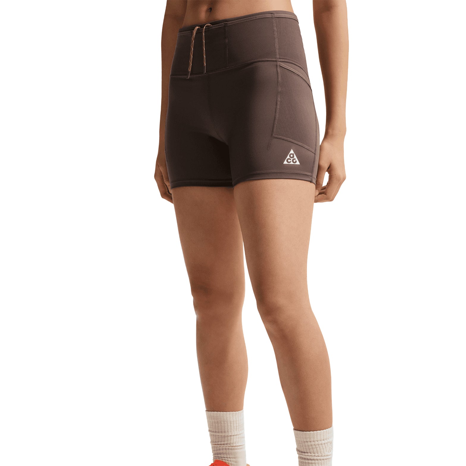 Women's Nike ACG High-Waisted 4 Inch Short Tights Ironstone Cave Stone Summit White front view on female runner showing high-waisted design with multiple mesh waistband pockets and Dri-FIT moisture-wicking construction