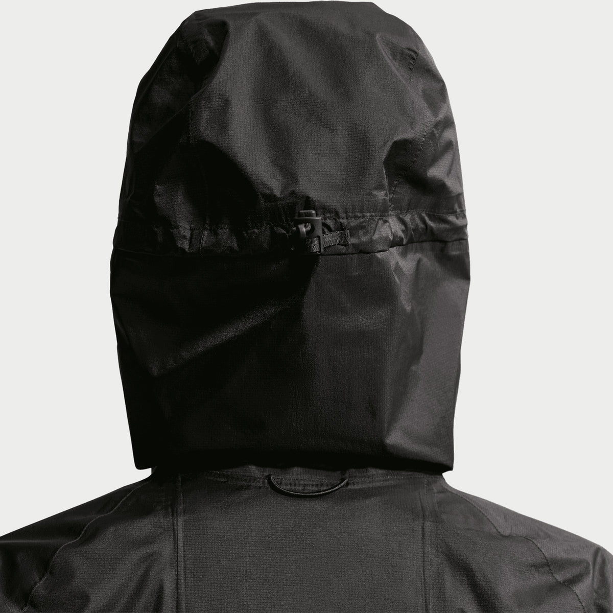 Women's Nike ACG Trailwind Storm-FIT ADV Jacket Black Summit White close-up of bungee-adjustable hood showing customisable coverage system with Storm-FIT ADV waterproof construction for unpredictable trail conditions