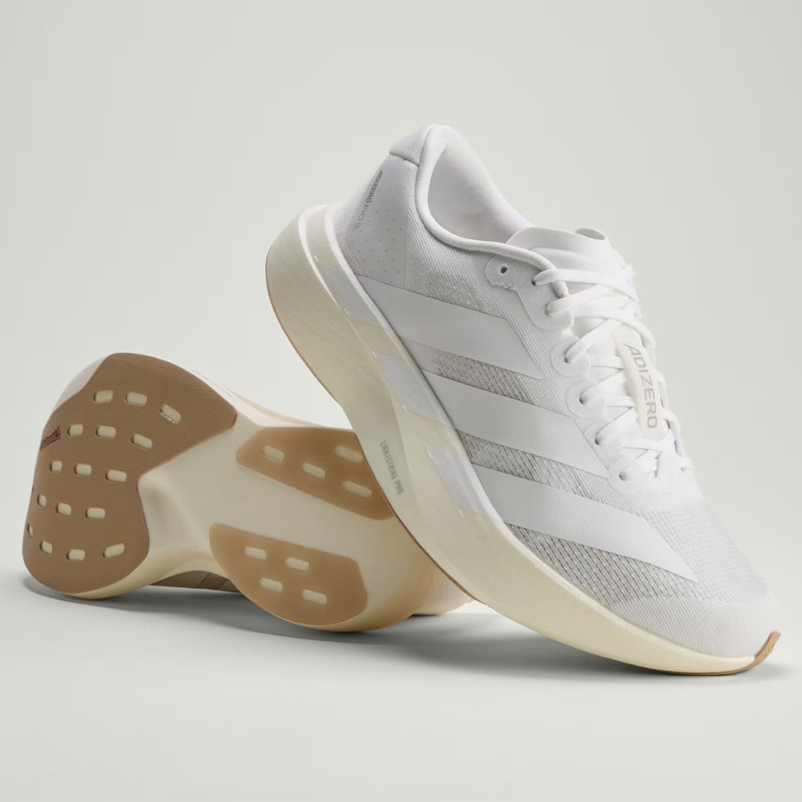 Women's adidas Adizero EVO SL Running Shoes Cloud White Cloud White Warm Sandstone sole view displaying Continental rubber forefoot and CL rubber rearfoot patches for traction and durability
