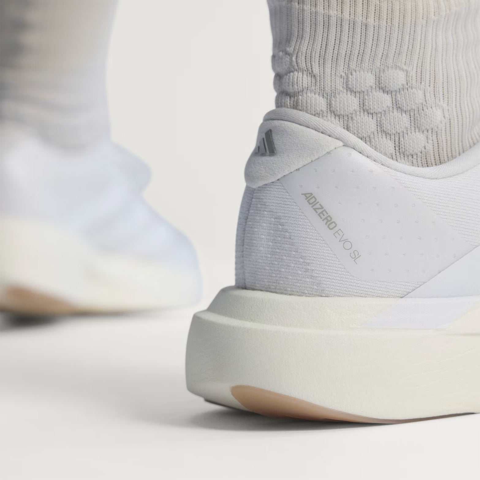 Women's adidas Adizero EVO SL Running Shoes Cloud White Cloud White Warm Sandstone heel view showing LIGHTSTRIKE PRO foam with regular fit and racing-inspired design